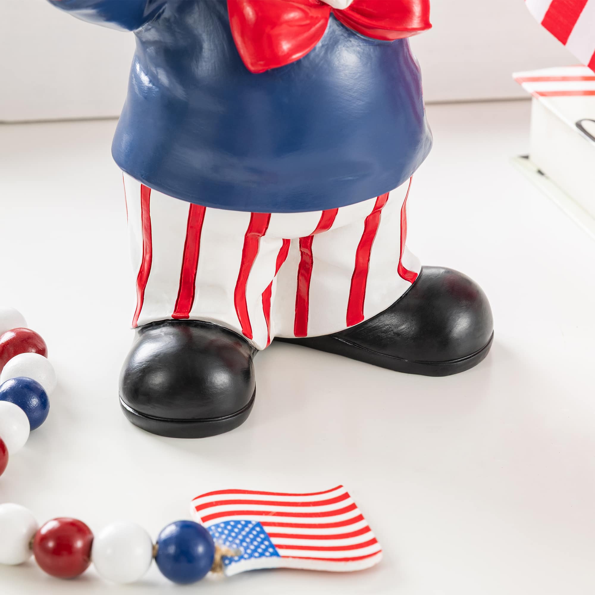 Glitzhome® 9" Patriotic Americana Polyresin Santa Holding Flags Table Decor