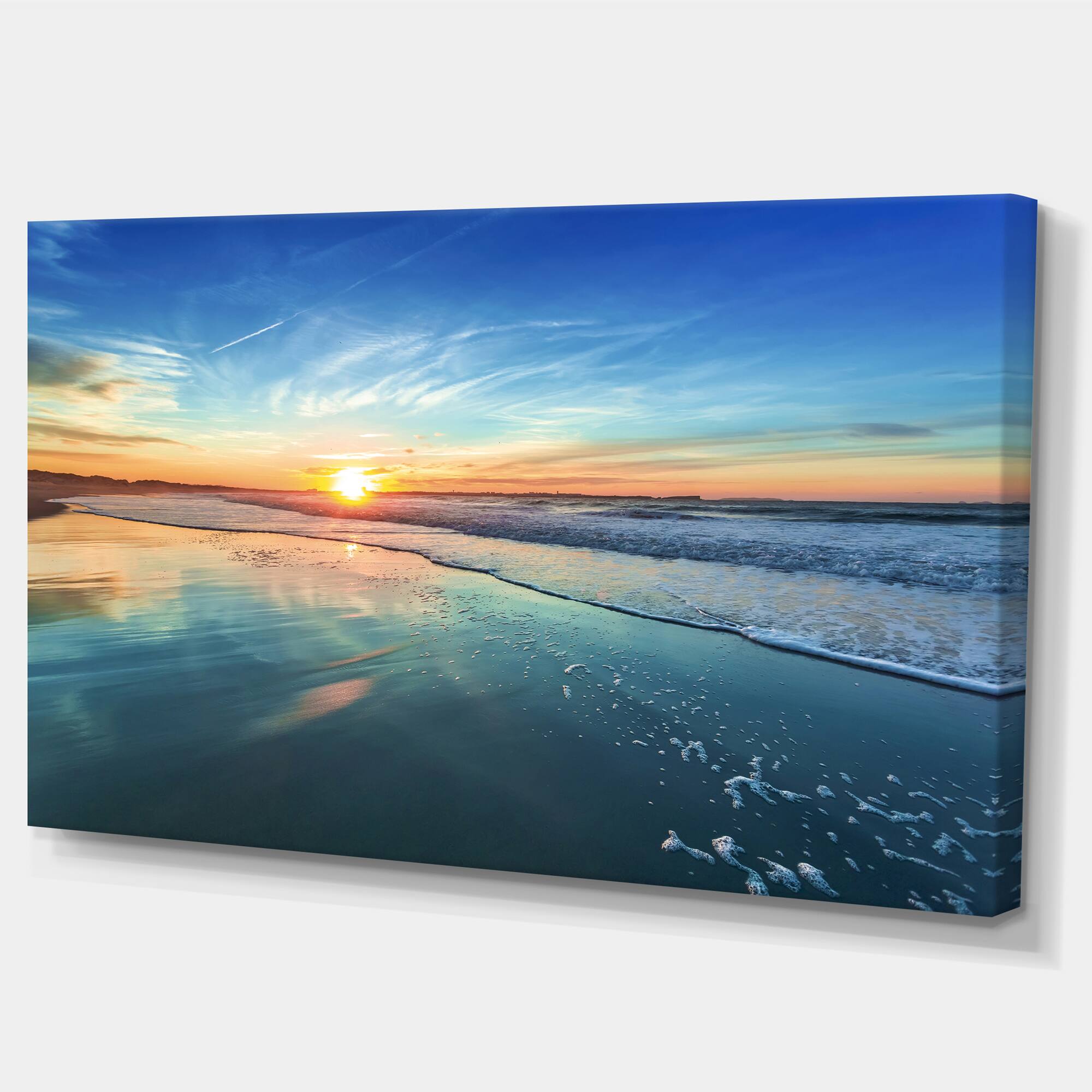 Designart - Blue Seashore with Distant Sunset