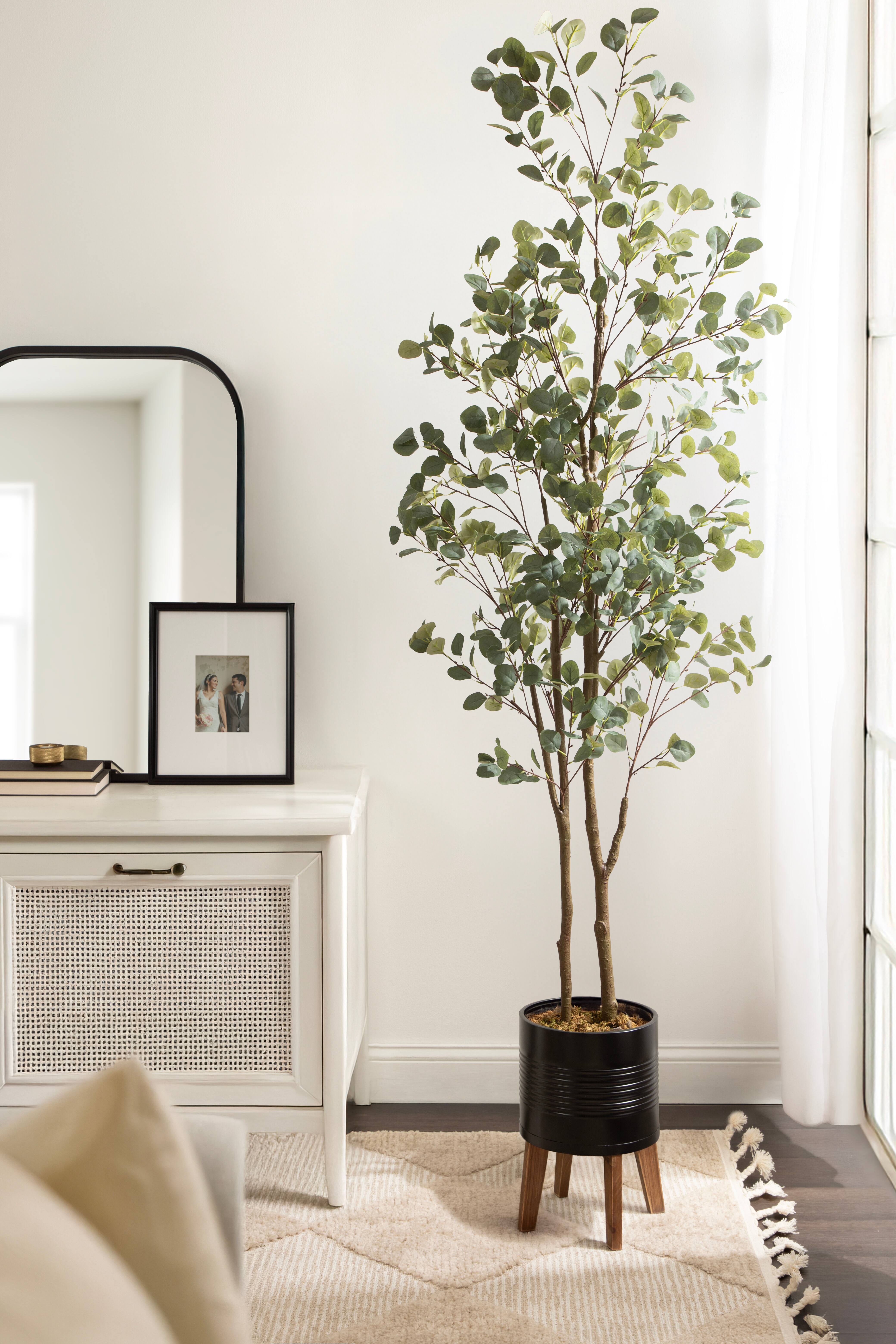 Kate and Laurel 8ft. Eudora Faux Eucalyptus Tree in Rustic Brown Footed Planter
