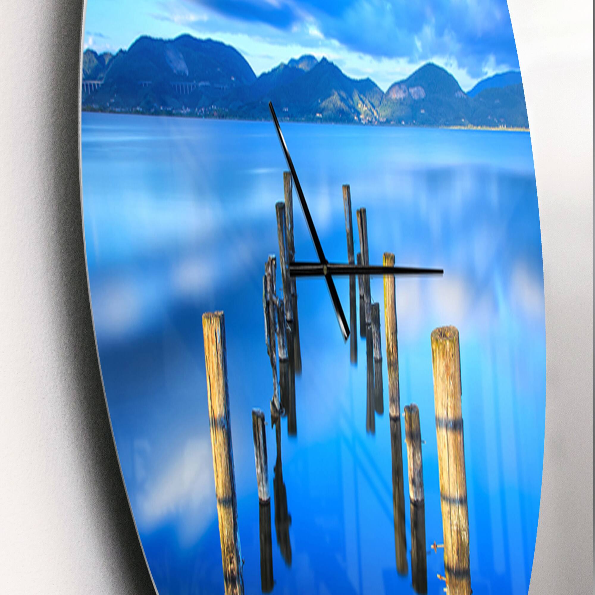 Designart 'Wooden Pier Remains In Blue Sea Modern Wall Clock