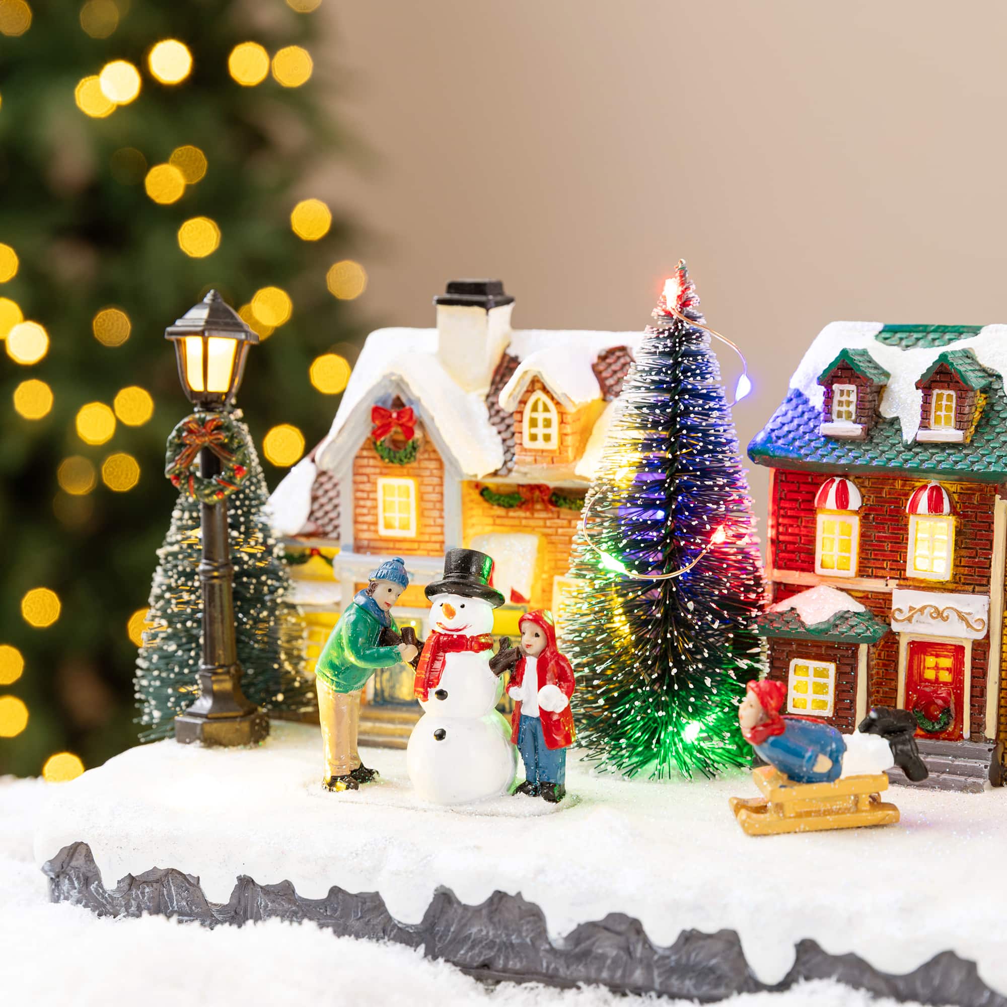 Glitzhome® 22" Lighted Christmas Santa Musical Resin Village with Timer