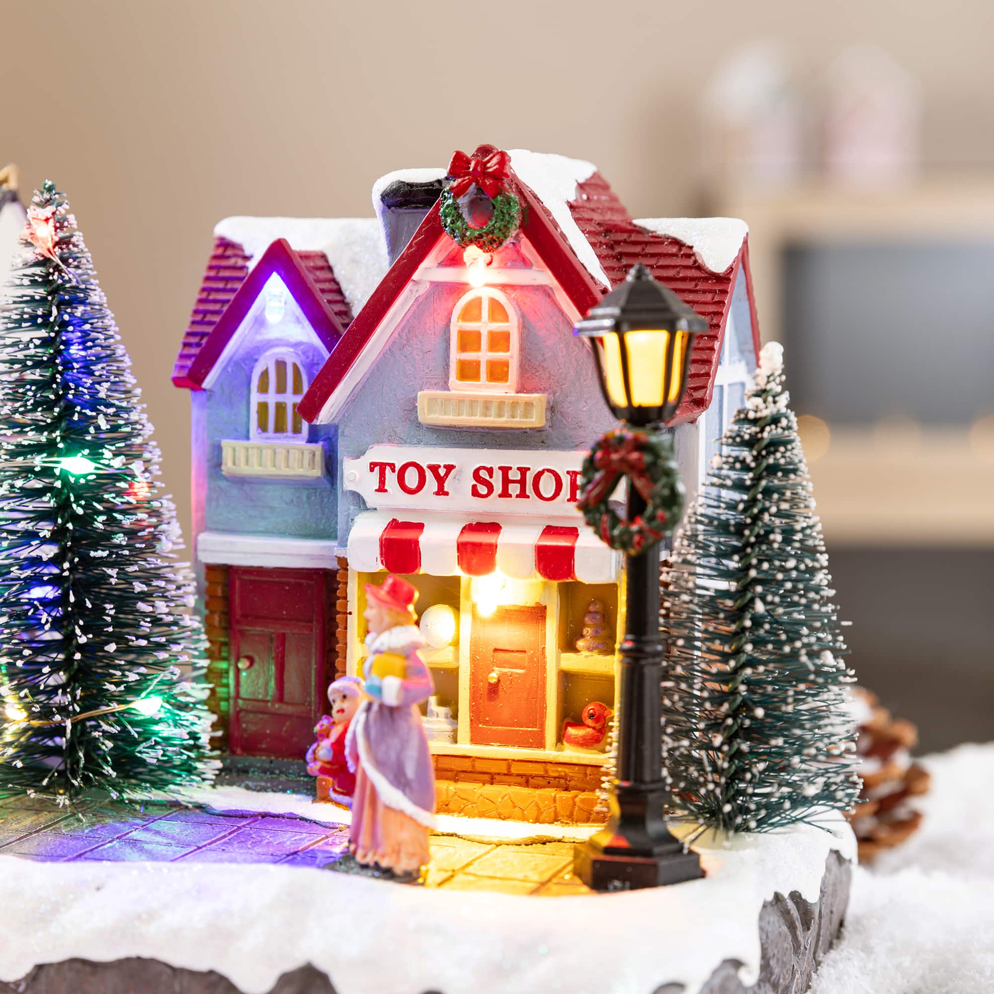 Glitzhome® 15.75" Lighted Christmas Resin Shop Avenue Musical Village with Timer