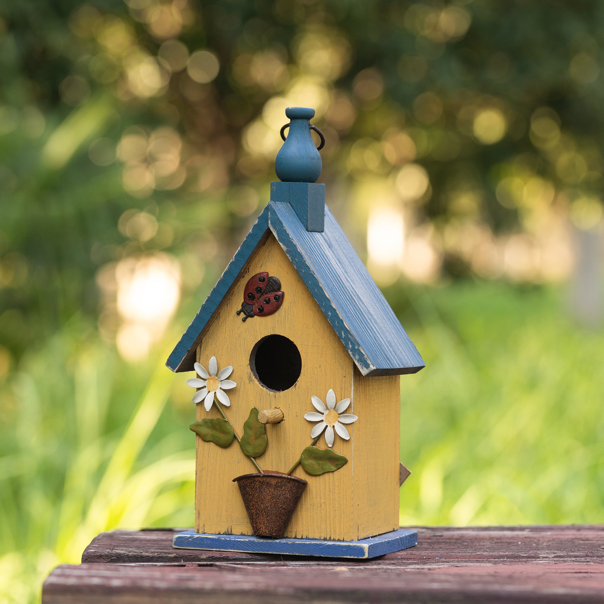 Glitzhome® 12.25" Washed Yellow Distressed Wood Cottage Birdhouse With Bees & Flowers