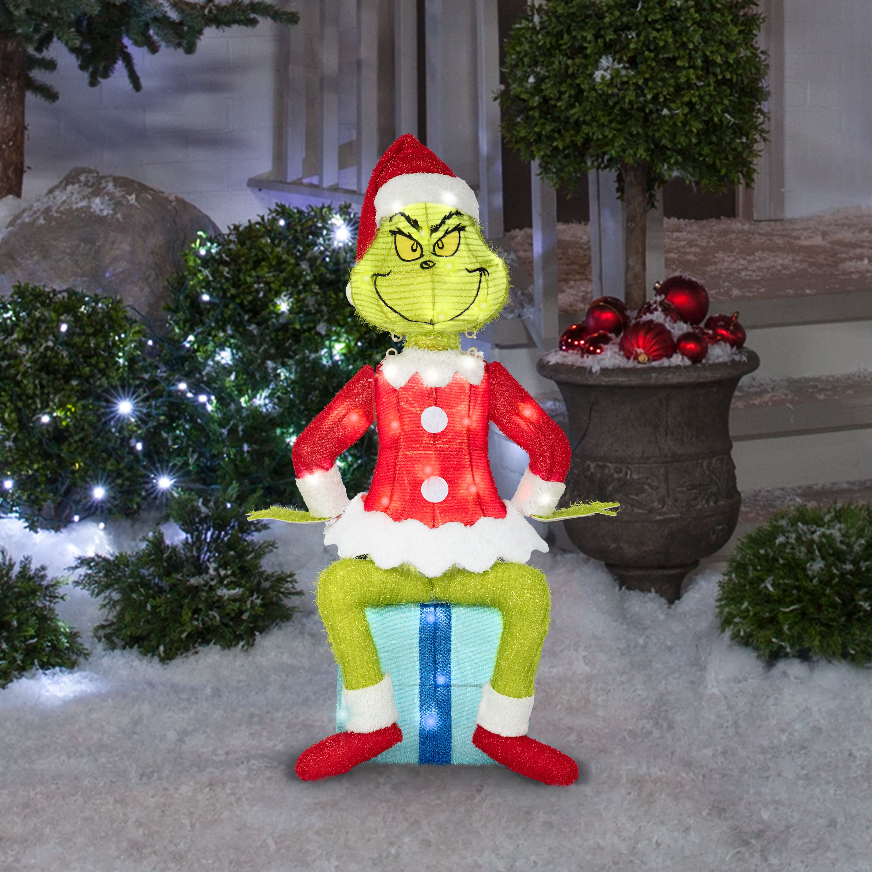 27.25" Dr. Seuss™ The Grinch Sitting on Present 3D Holiday Lighted Tinsel Sculpture Christmas Décor