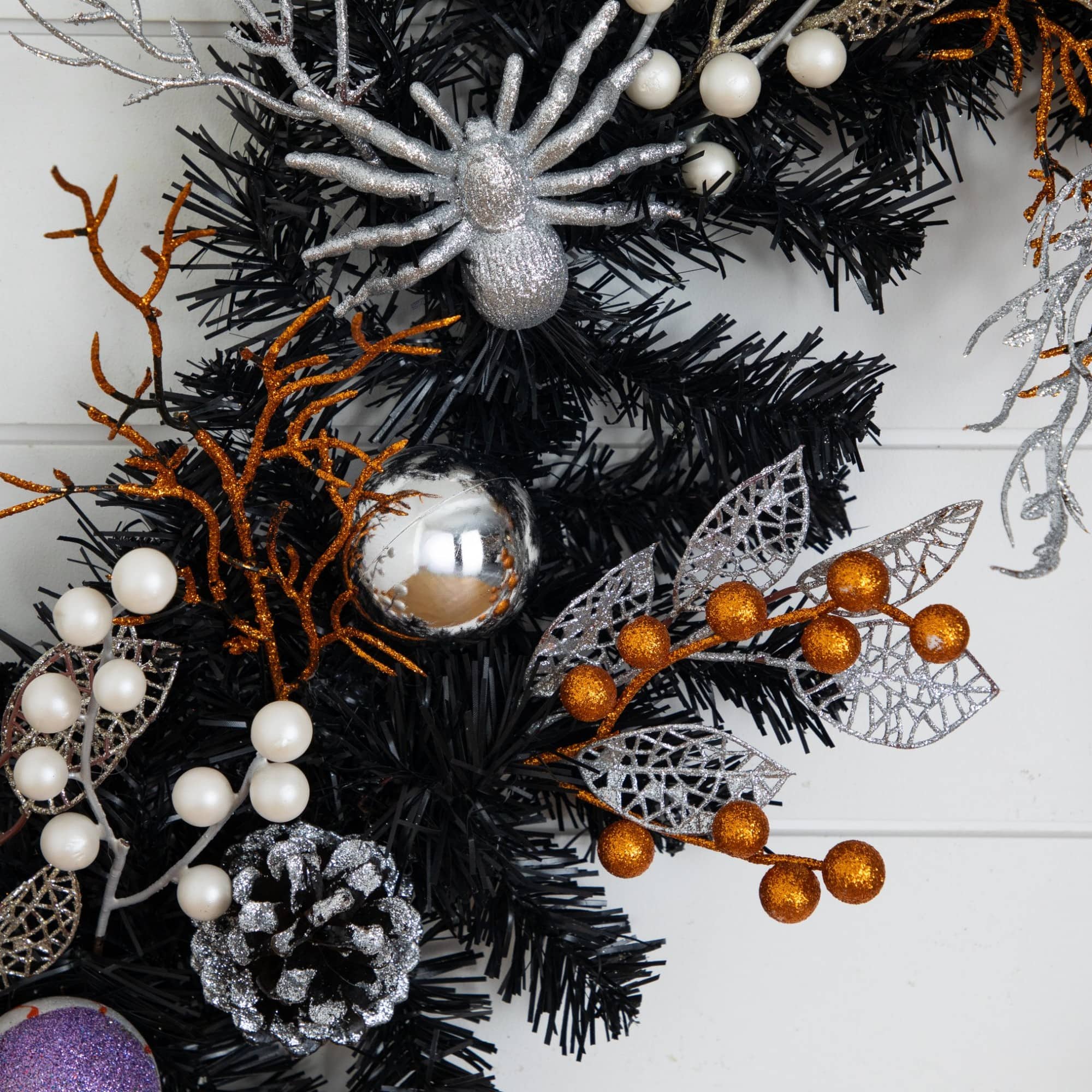 6ft. Artificial Halloween Black Garland with Skulls, Eyeballs & Spiders