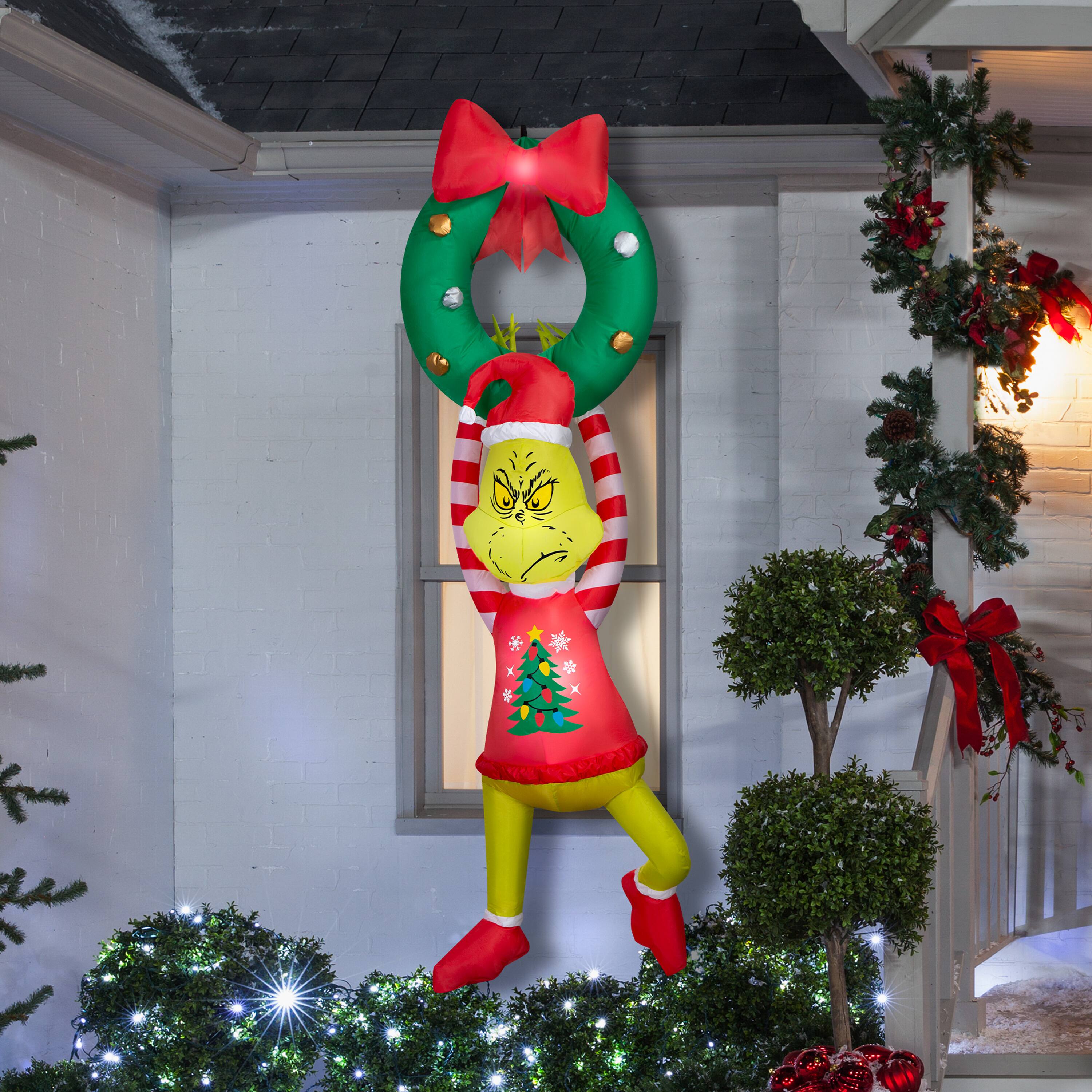 6.5ft. Airblown® Dr. Seuss™ Inflatable Grinch Hanging from Wreath with Red Bow Christmas Light Décor