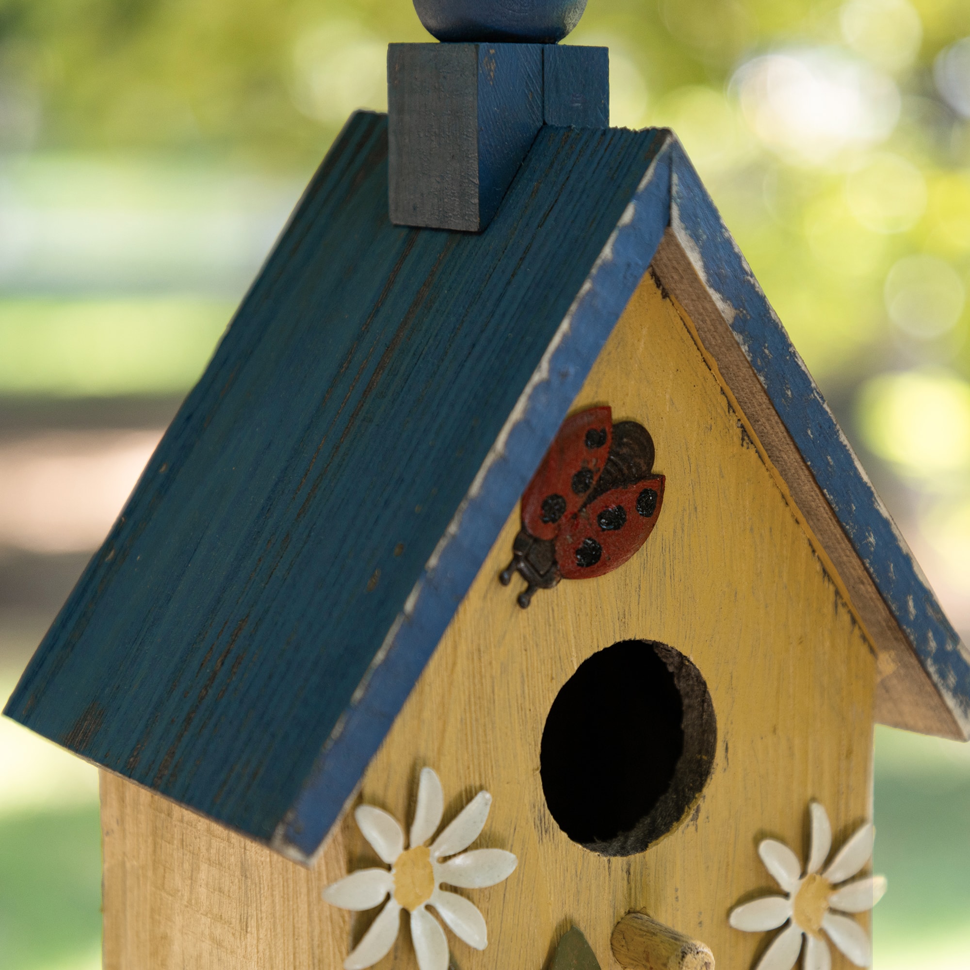 Glitzhome® 12.25" Washed Yellow Distressed Wood Cottage Birdhouse With Bees & Flowers