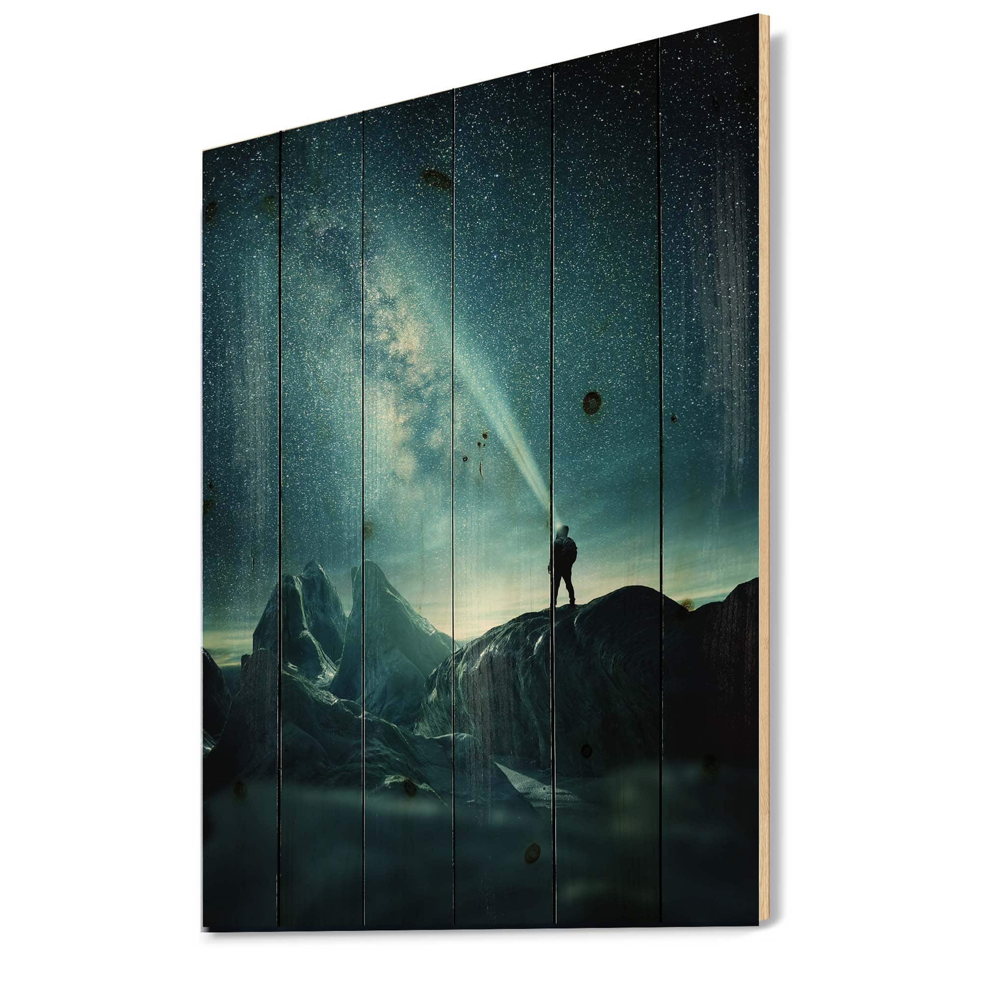 Designart - A Man Shining A Light Into The Night Sky