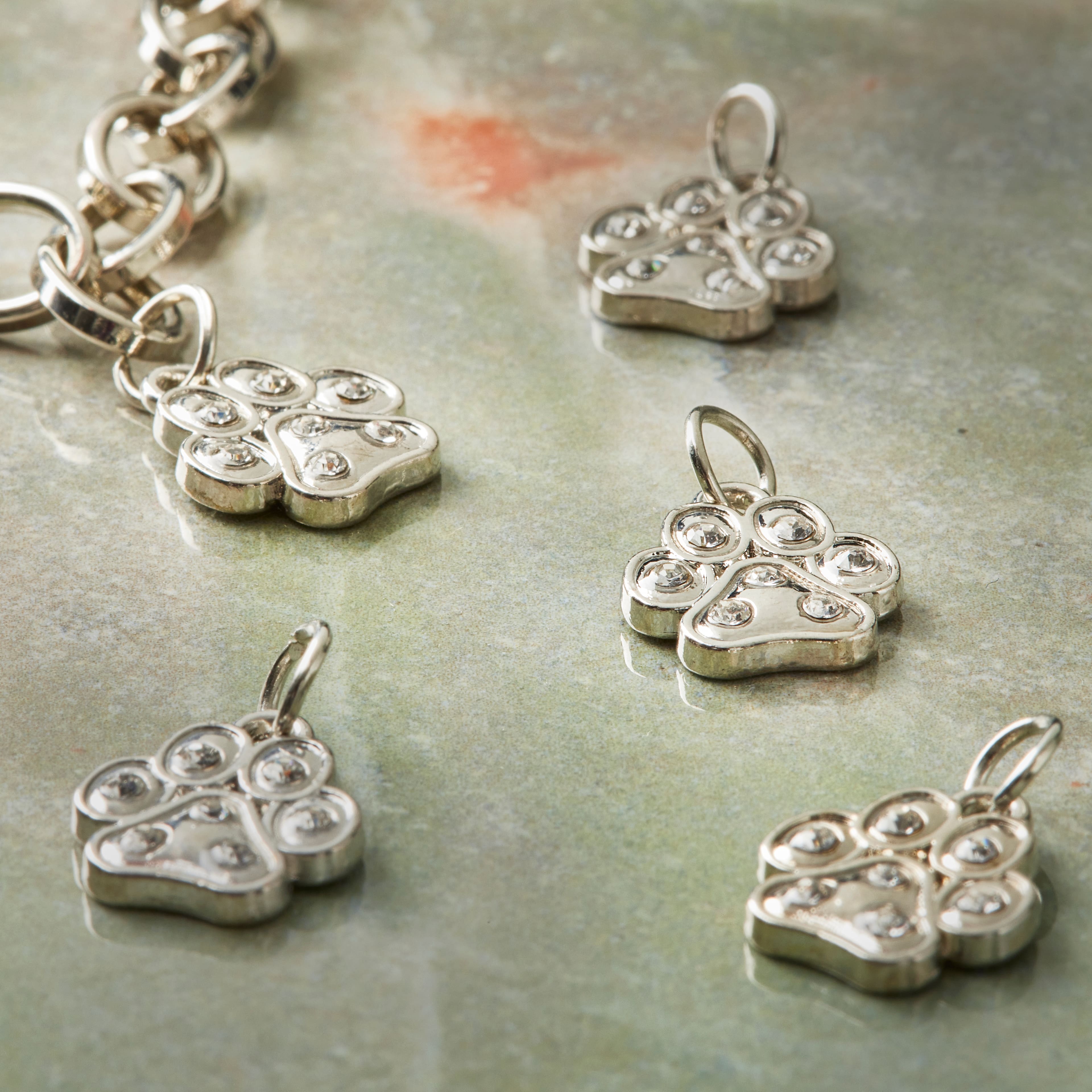 12 Packs: 12 ct. (144 total) Charmalong™ Rhodium Paw Charms by Bead Landing™