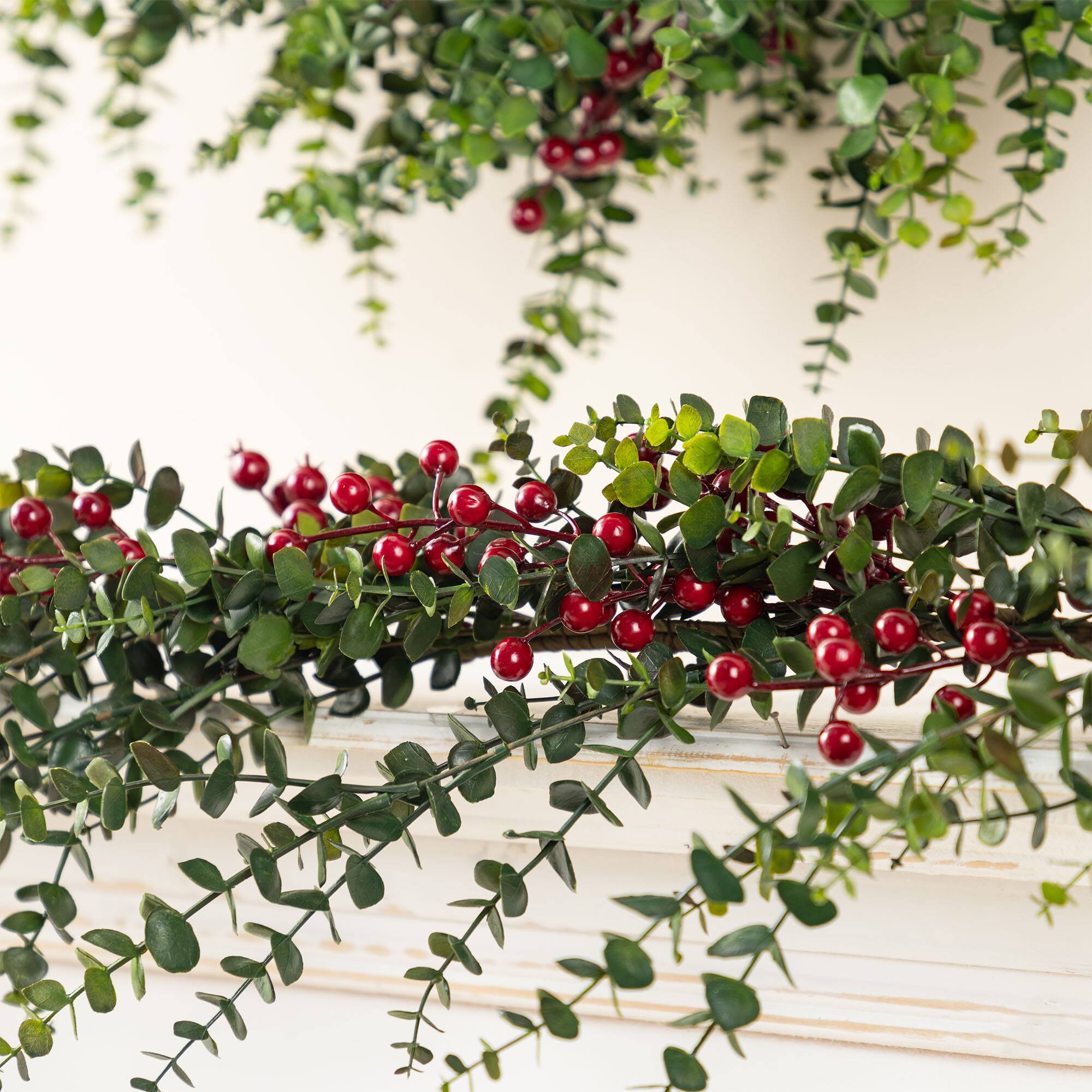 Glitzhome® 9ft. Christmas Greenery PE Dripping Eucalyptus Garland with Red Berries, Set of 2