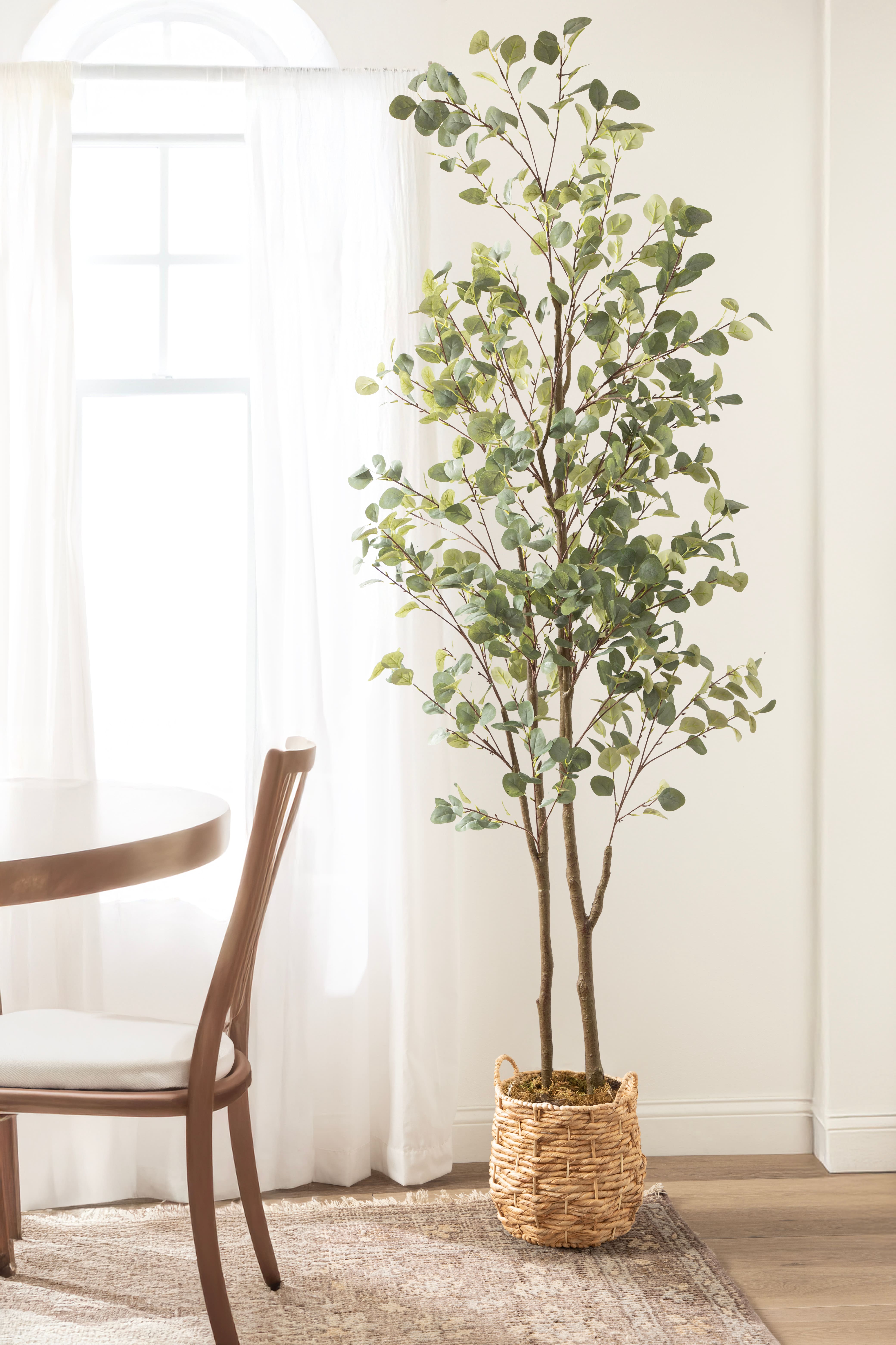 Kate and Laurel 8ft. Eudora Faux Eucalyptus Tree with Natural Planter