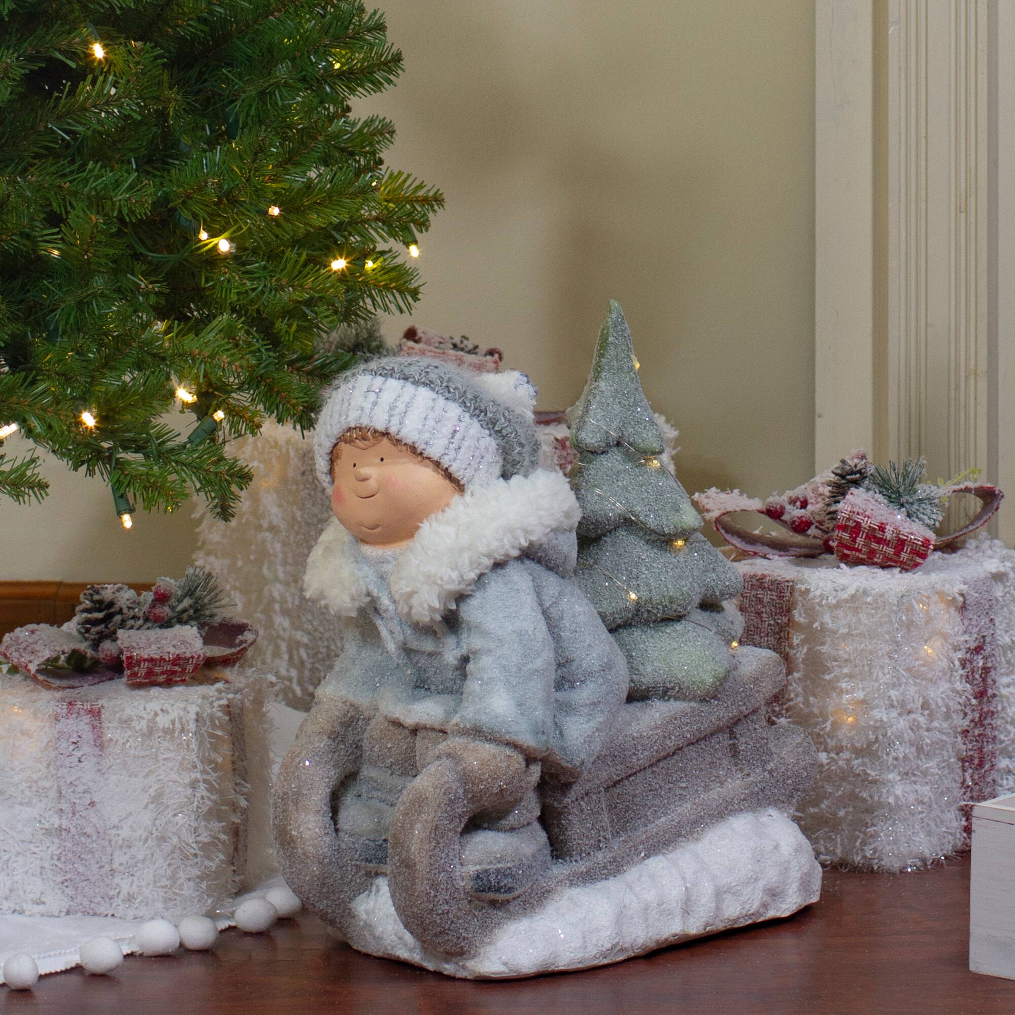 15" Beige & Green Lighted Boy on a Sled Christmas Decoration