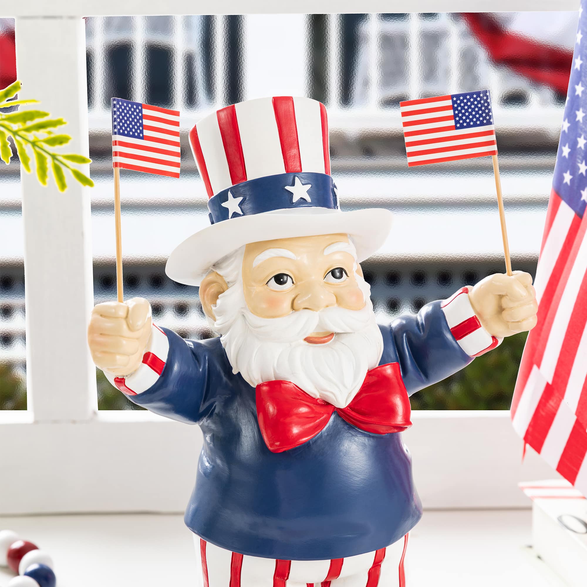 Glitzhome® 9" Patriotic Americana Polyresin Santa Holding Flags Table Decor