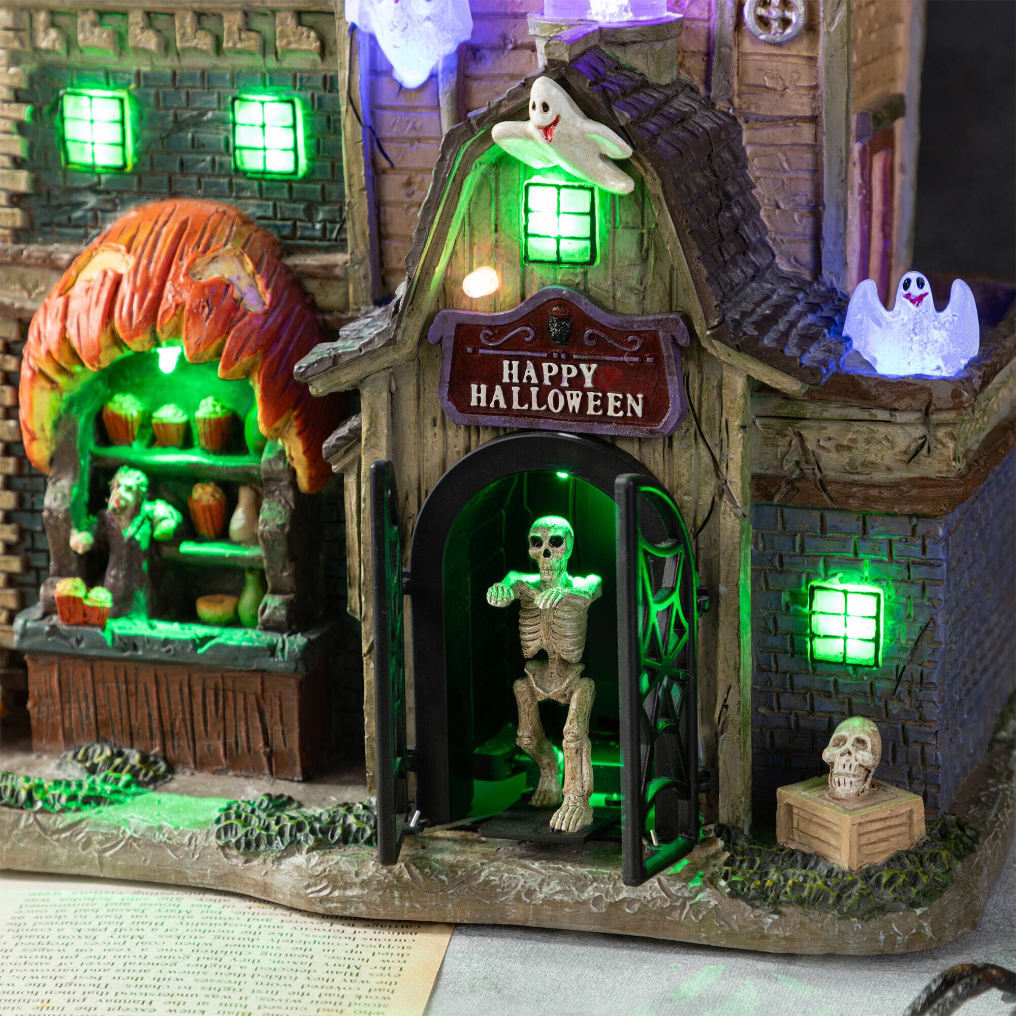 Glitzhome® 11"H Lighted Resin Halloween Haunted House Village