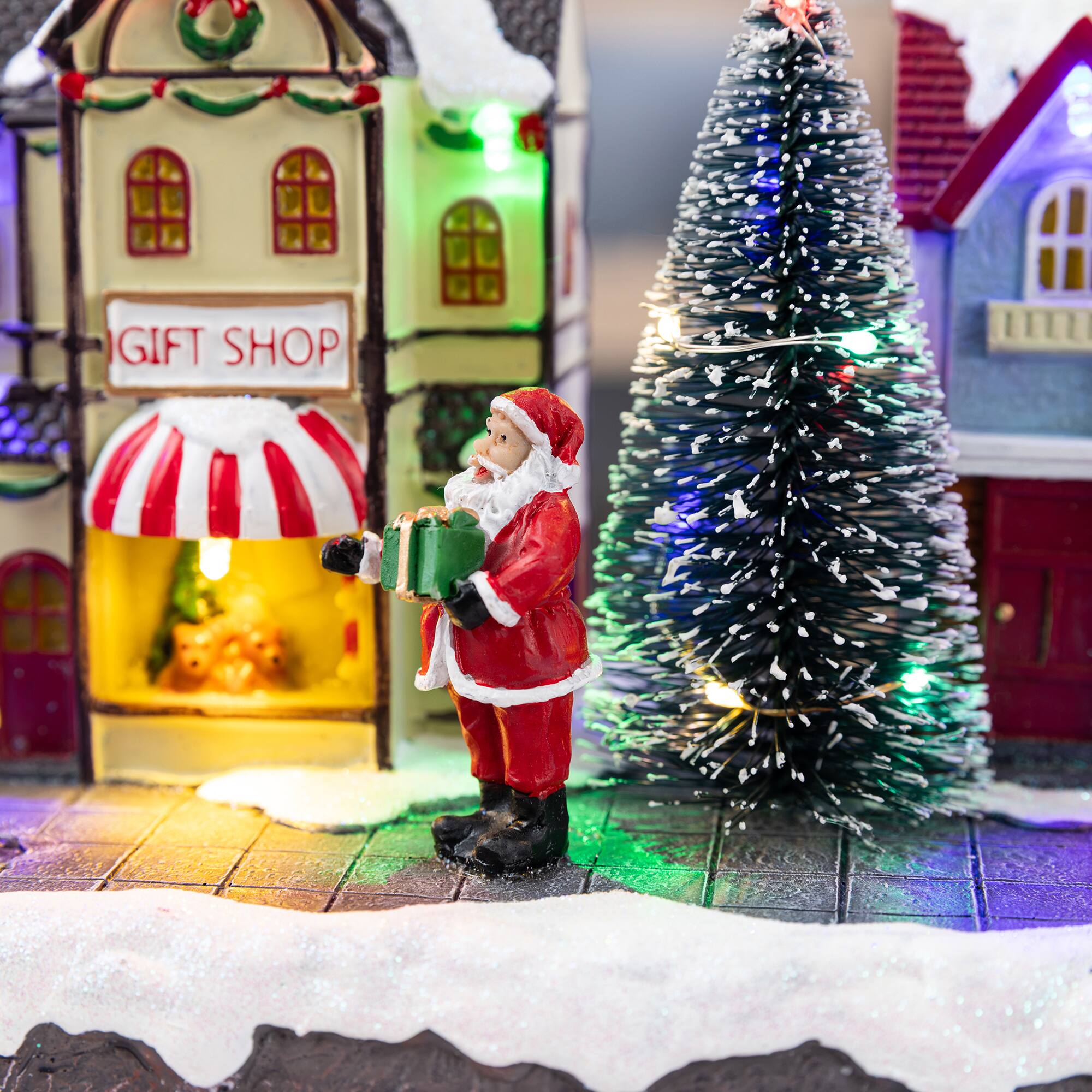 Glitzhome® 15.75" Lighted Christmas Resin Shop Avenue Musical Village with Timer