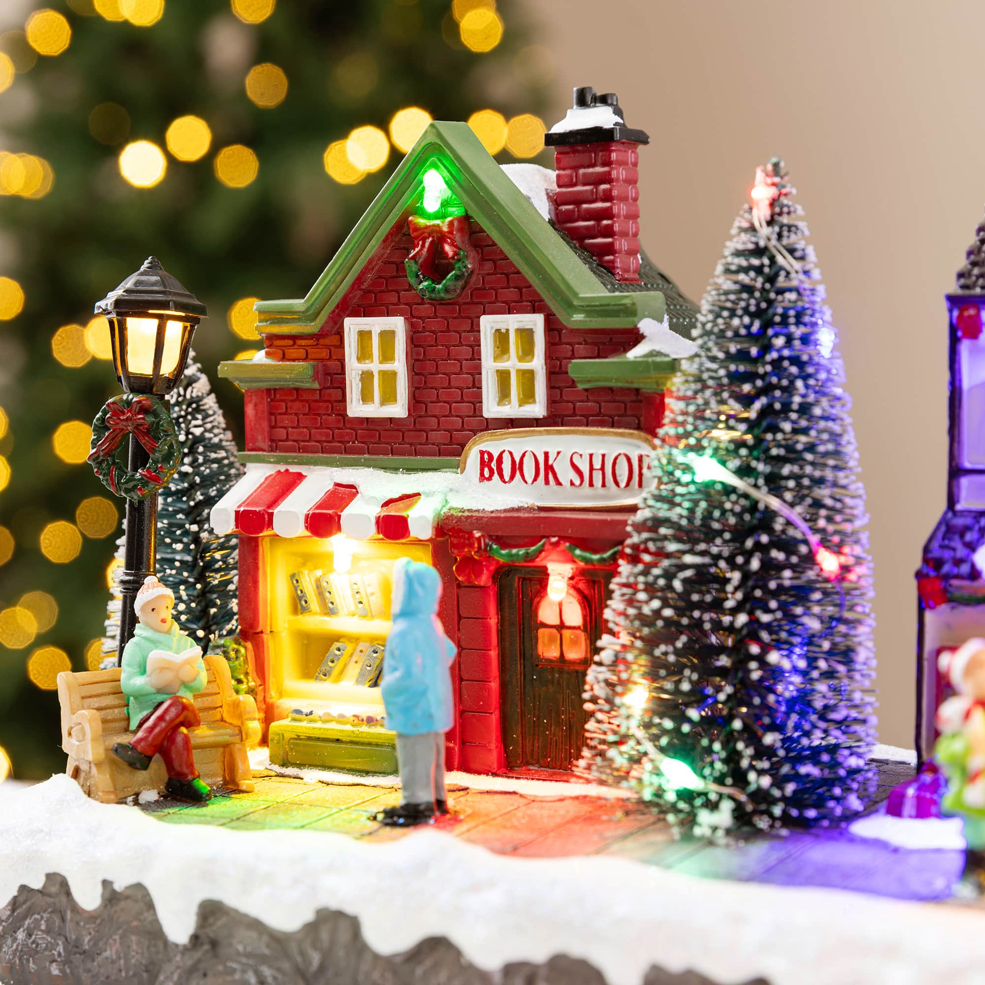 Glitzhome® 15.75" Lighted Christmas Resin Shop Avenue Musical Village with Timer