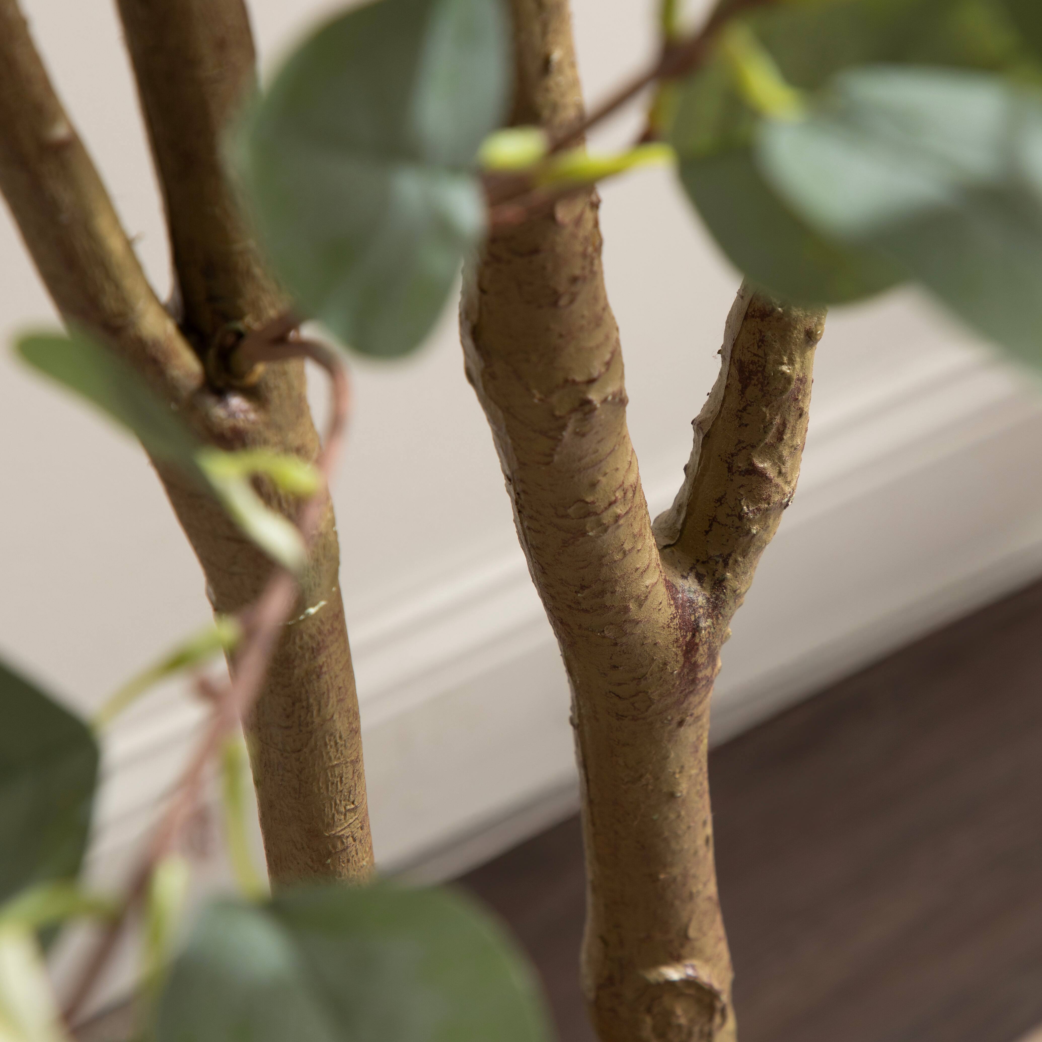 Kate and Laurel 8ft. Eudora Faux Eucalyptus Tree in Rustic Brown Footed Planter
