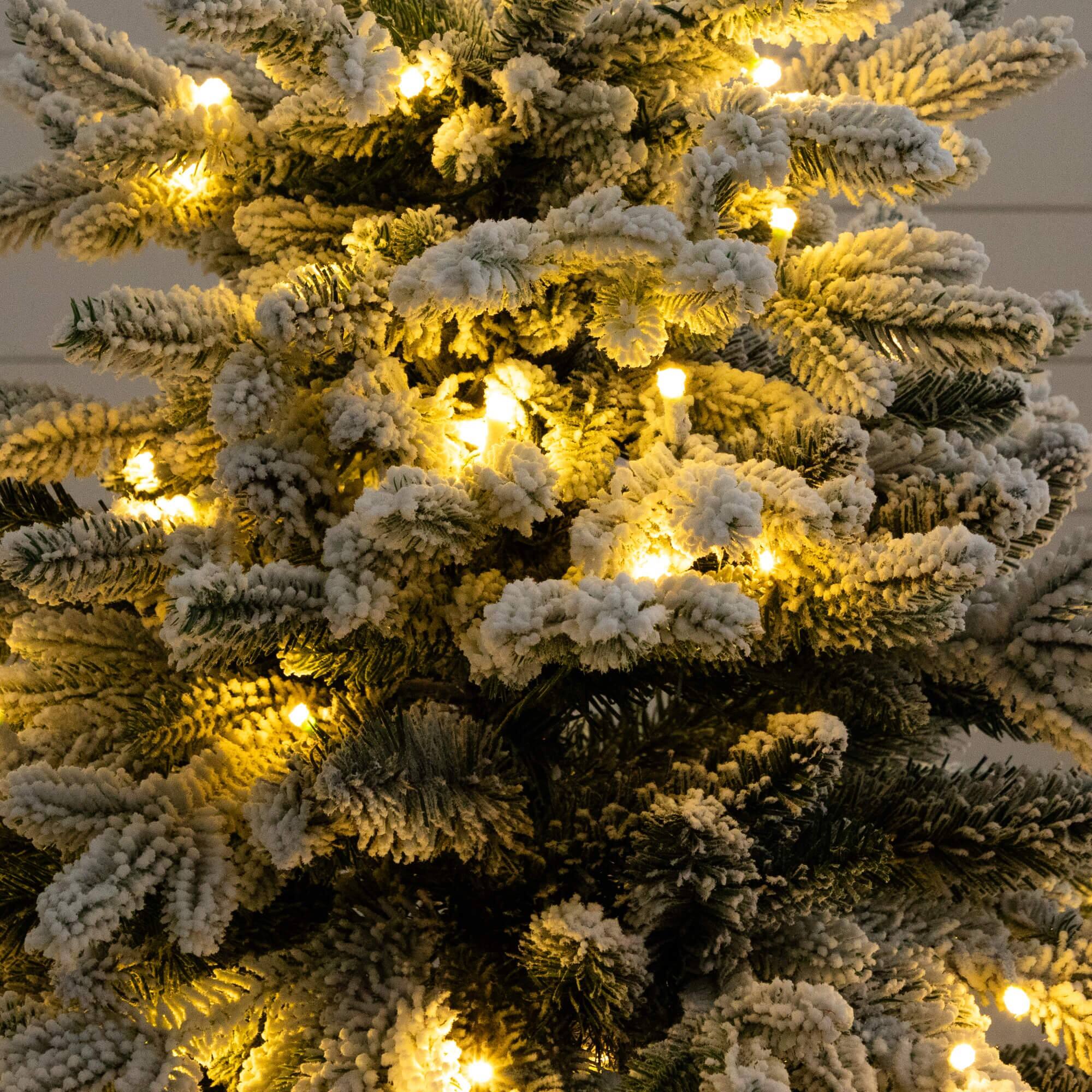4ft. Pre-Lit Flocked Artificial Christmas Tree in Black Decorative Planter, Warm White LED Lights