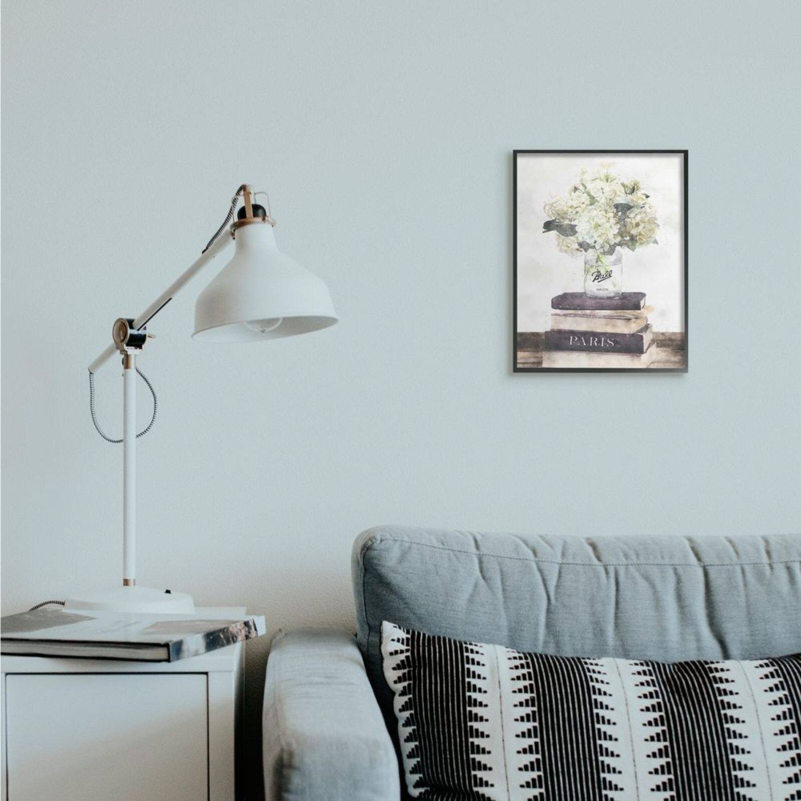 Stupell Industries White Florals on Parisian Bookstack with Black Frame Wall Accent