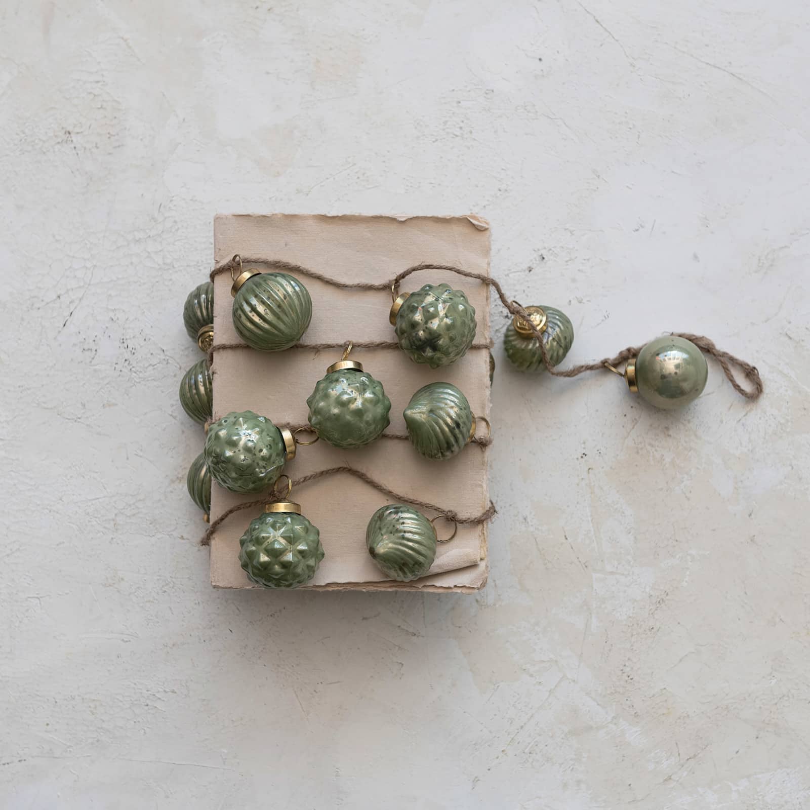 Hello Honey® 6ft. Olive Green Embossed Mercury Glass Ball Ornament Garland