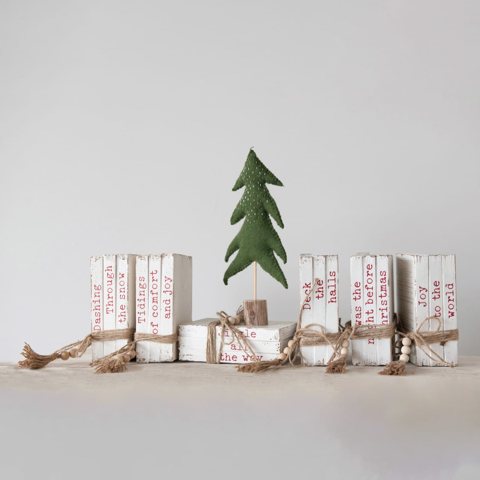 Hello Honey® 8.5" White & Red 6-Piece Wood Block Faux Books with Holiday Saying, Wood Beads & Jute Tie