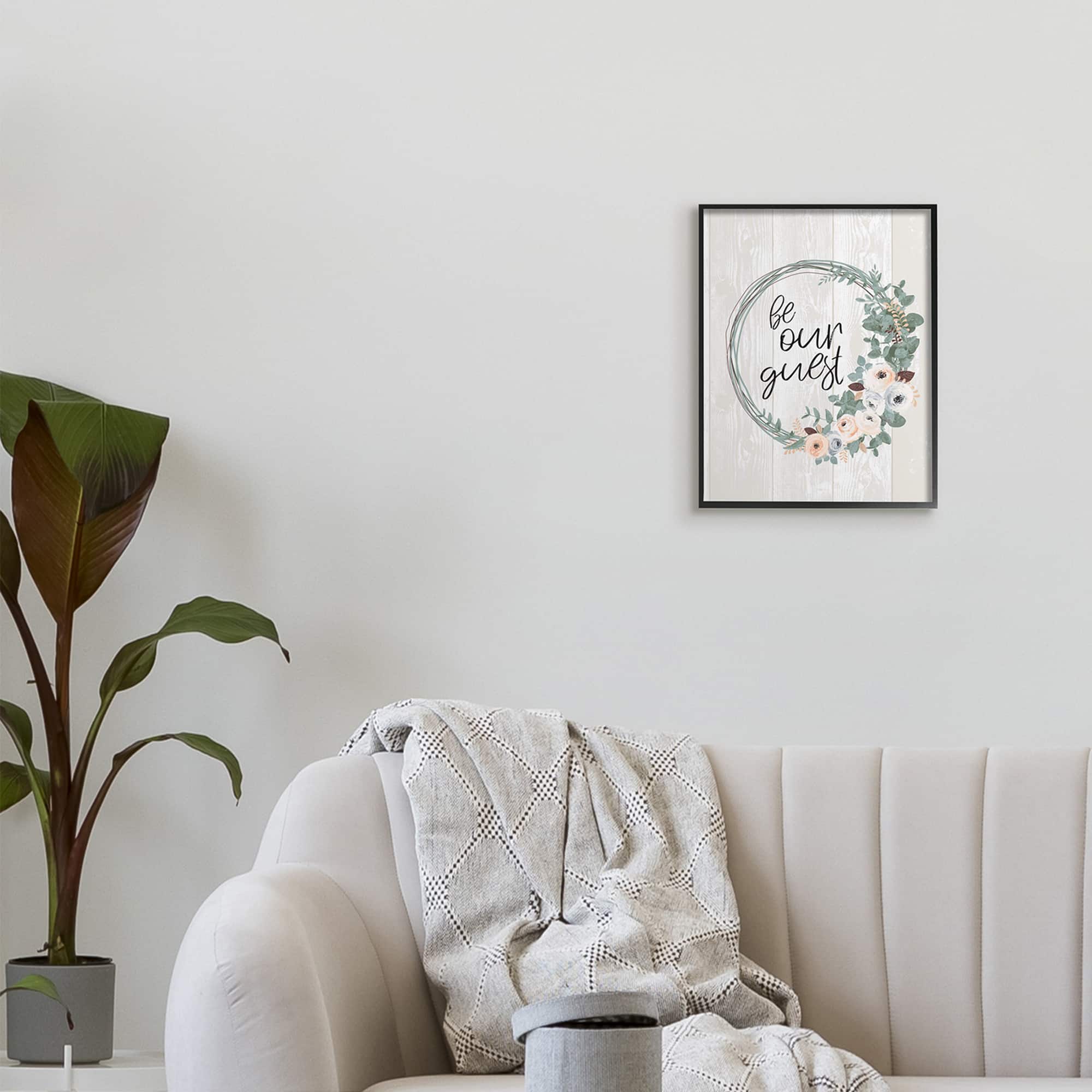 Stupell Industries Be Our Guest Greeting Charming Floral Wreath in Black Frame Wall Art