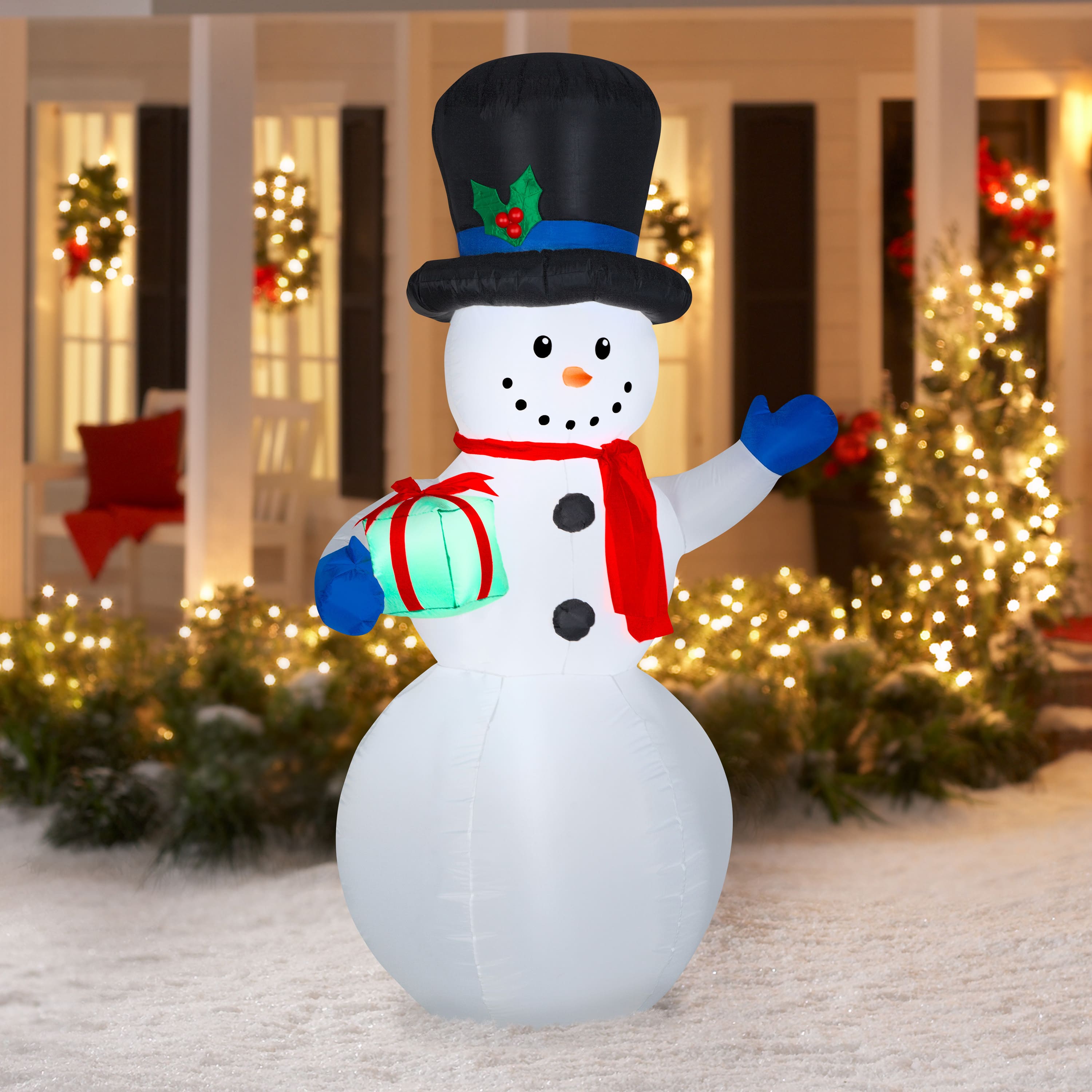 7ft. Airblown® Inflatable Snowman with Gift | Michaels
