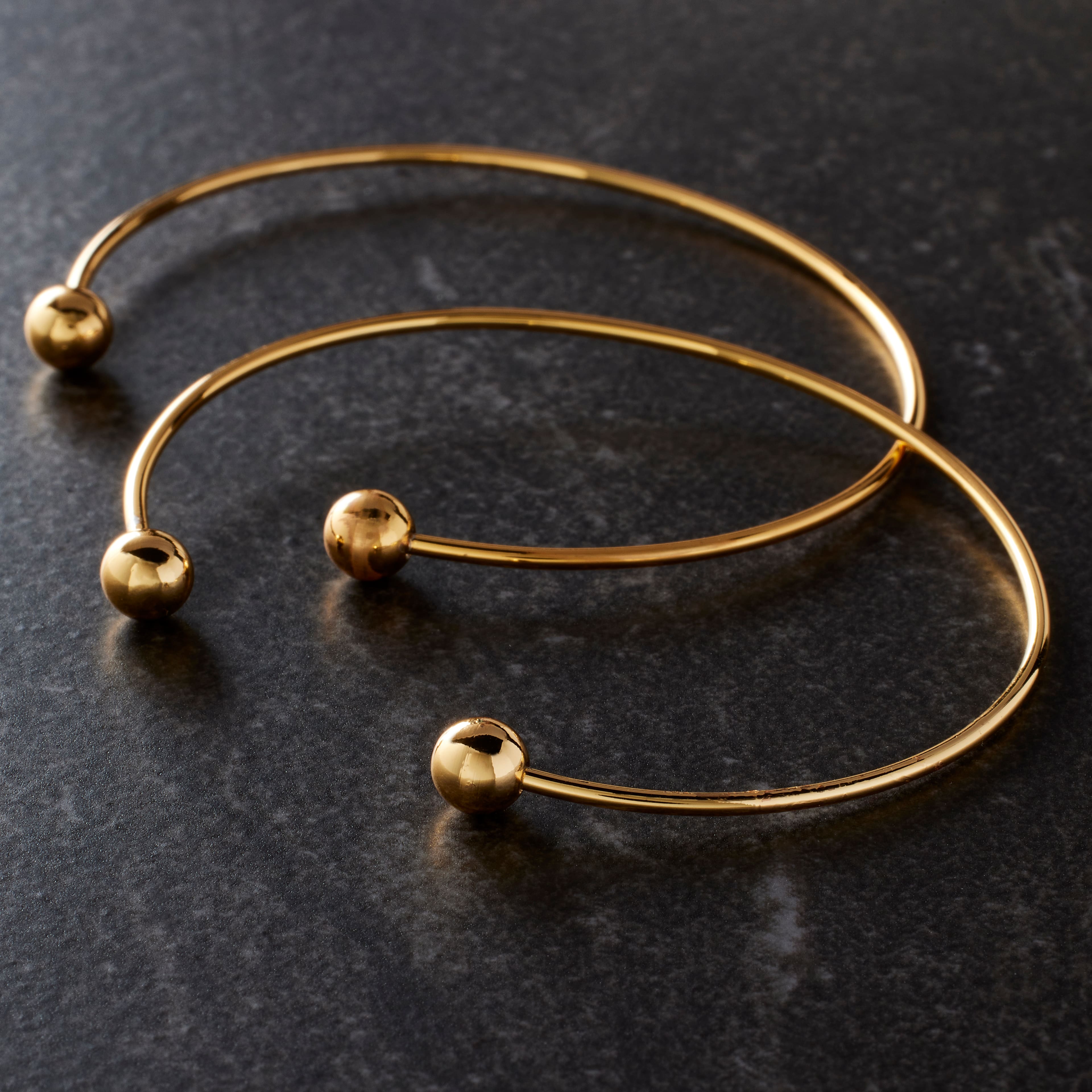 12 Packs: 2 ct. (24 total) 65mm Gold Charm Bangles by Bead Landing™