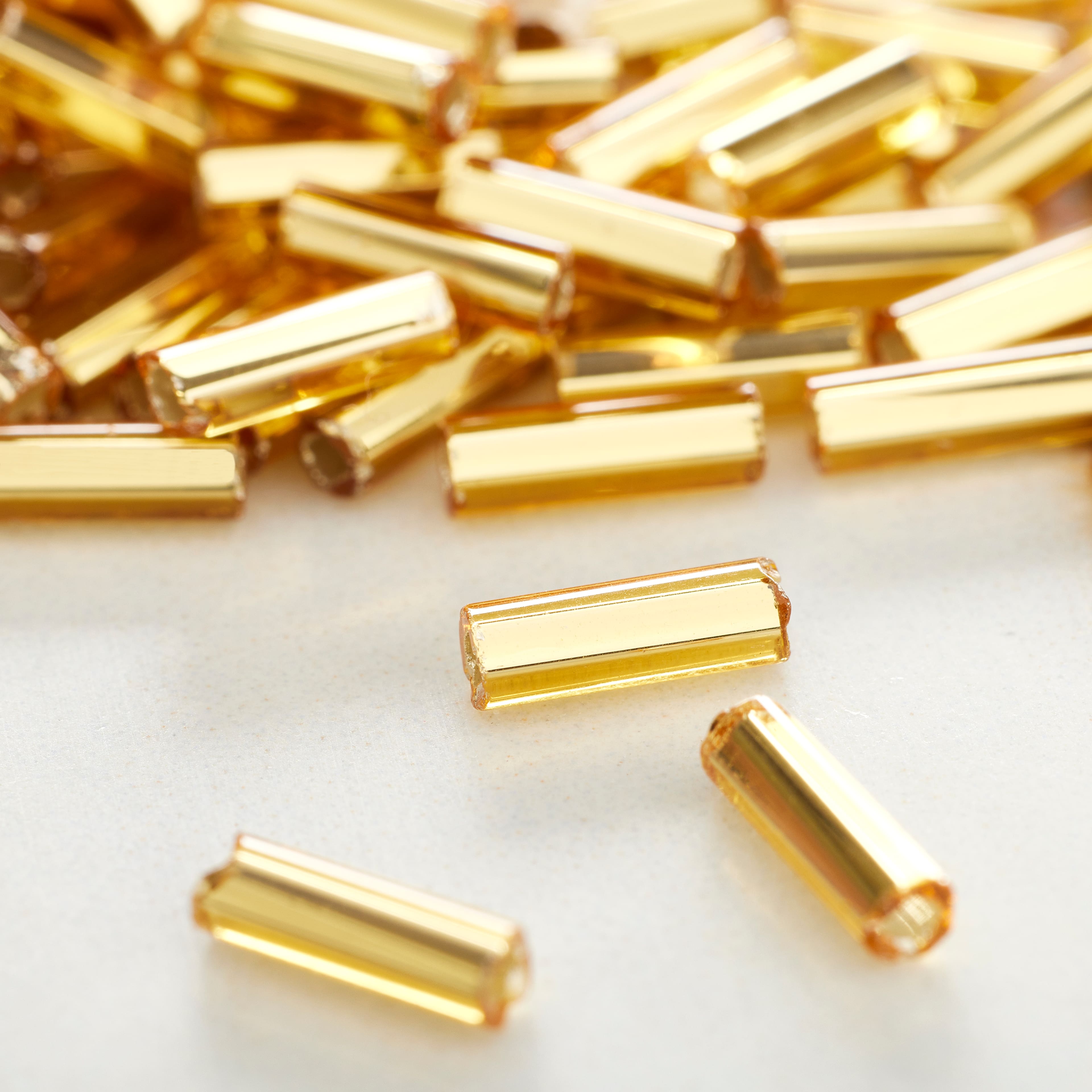 12 Pack: John Bead Topaz Silver Lined Czech Glass Bugle Beads, 6.5mm