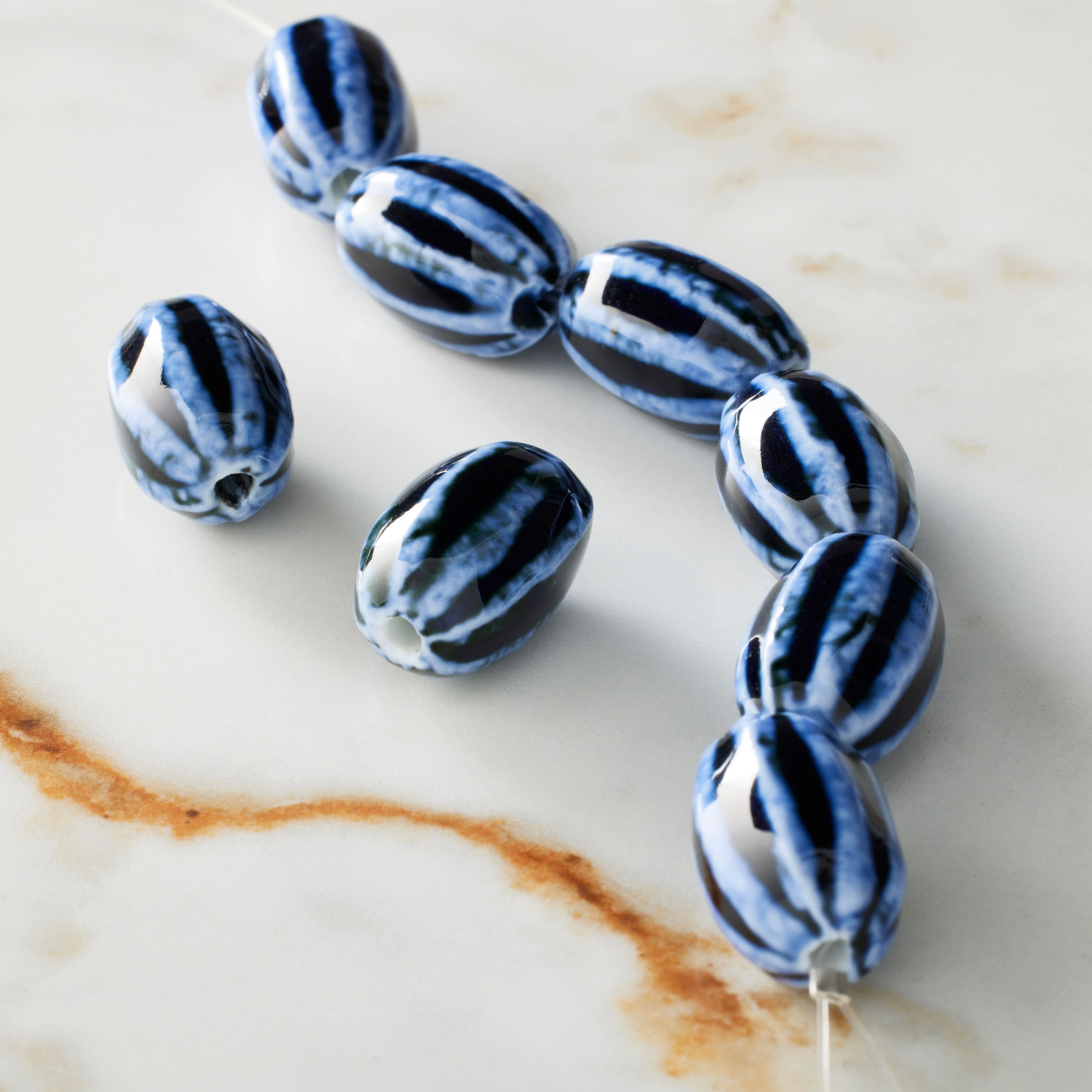 12 Packs: 8 ct. (96 total) Blue Lined Ceramic Oval Beads, 20mm by Bead Landing™
