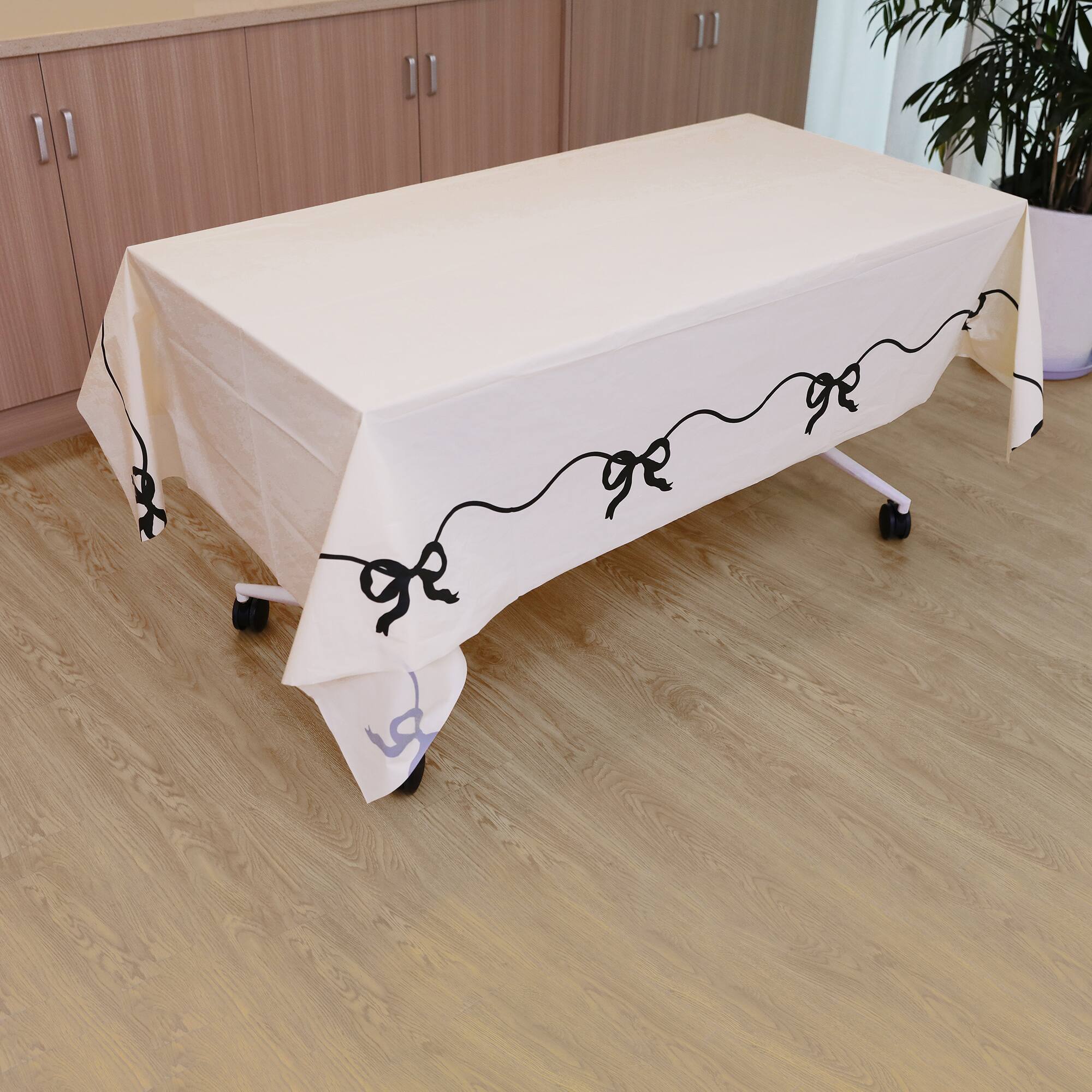 24 Pack: 54" x 108" Black Bows Plastic Table Cover by Celebrate It™