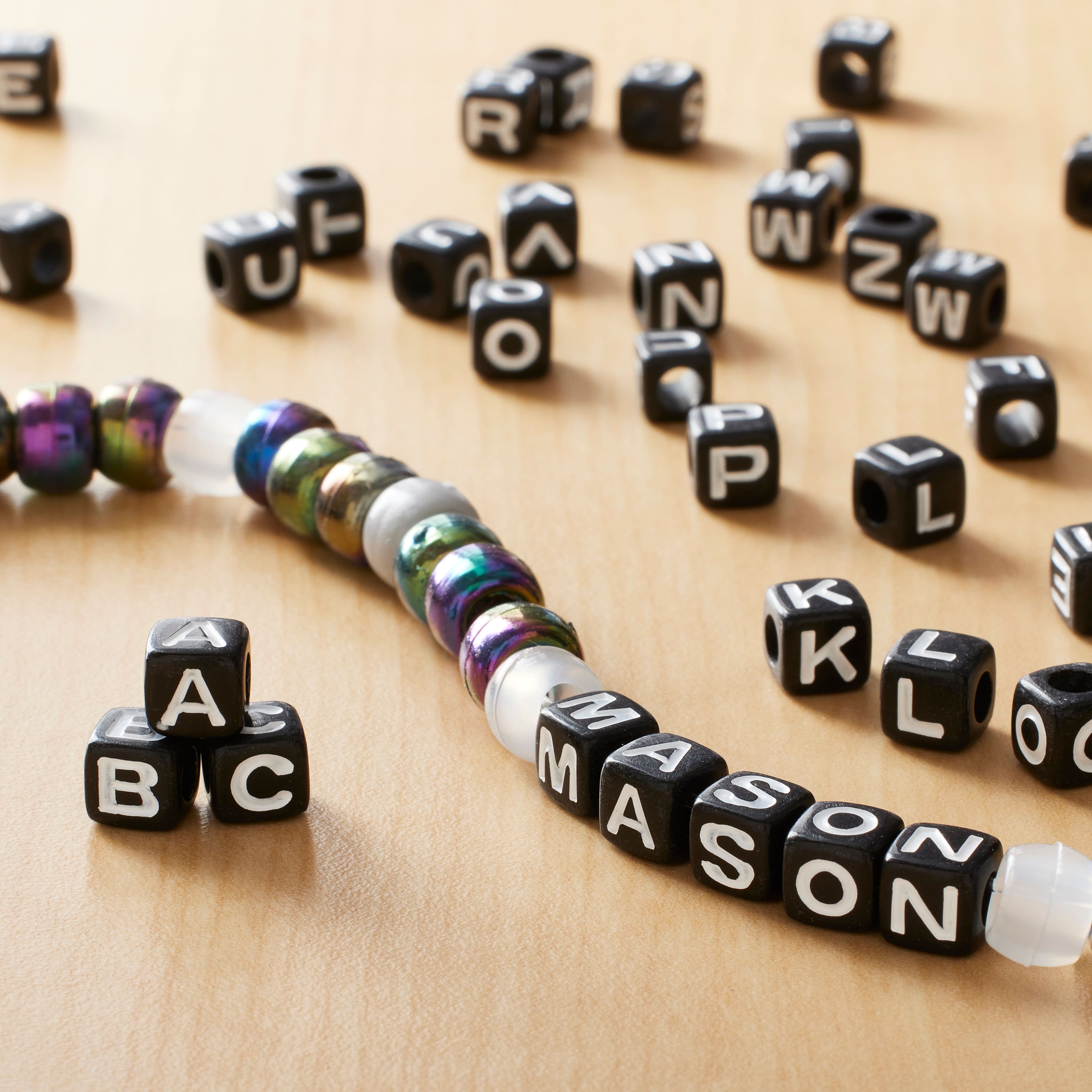 12 Pack: 1/2lb. Black Square Alphabet Beads by Creatology™, 6.5mm 