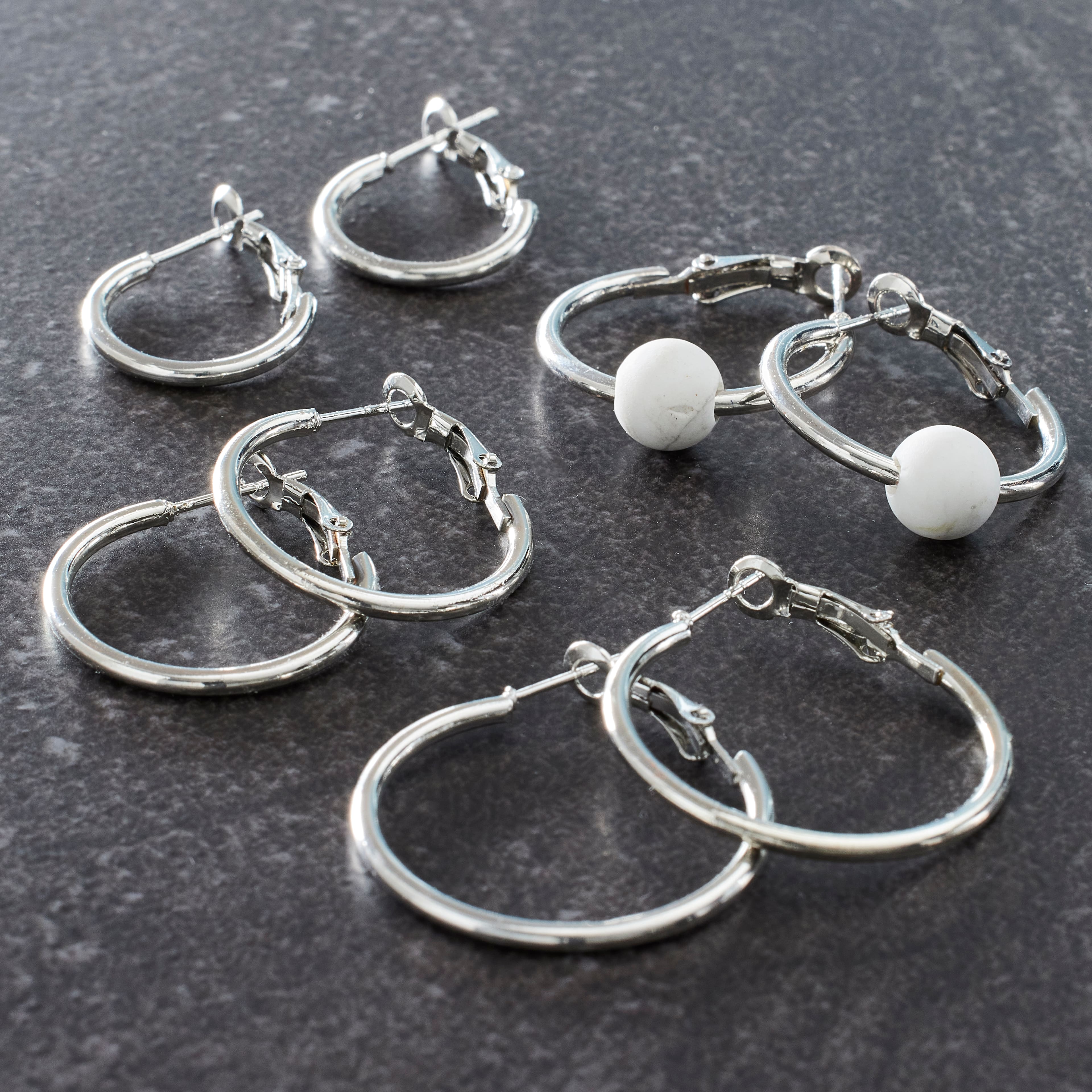 12 Packs: 4 ct. (48 total) Silver Hoop Earrings by Bead Landing®