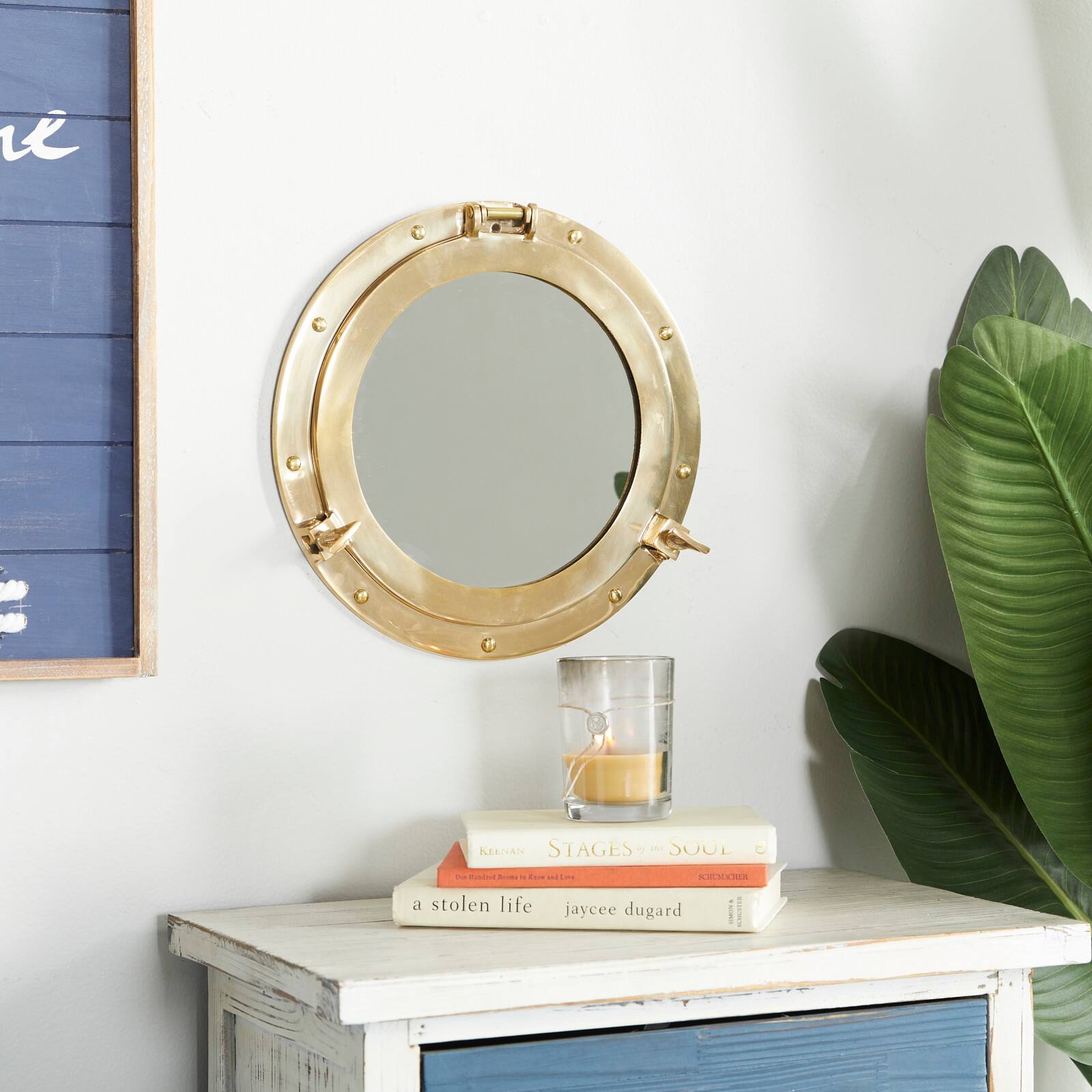 The Novogratz Gold Brass Sail Boat Wall Mirror with Port Hole Detailing 12&#x22; x 2&#x22; x 12&#x22;