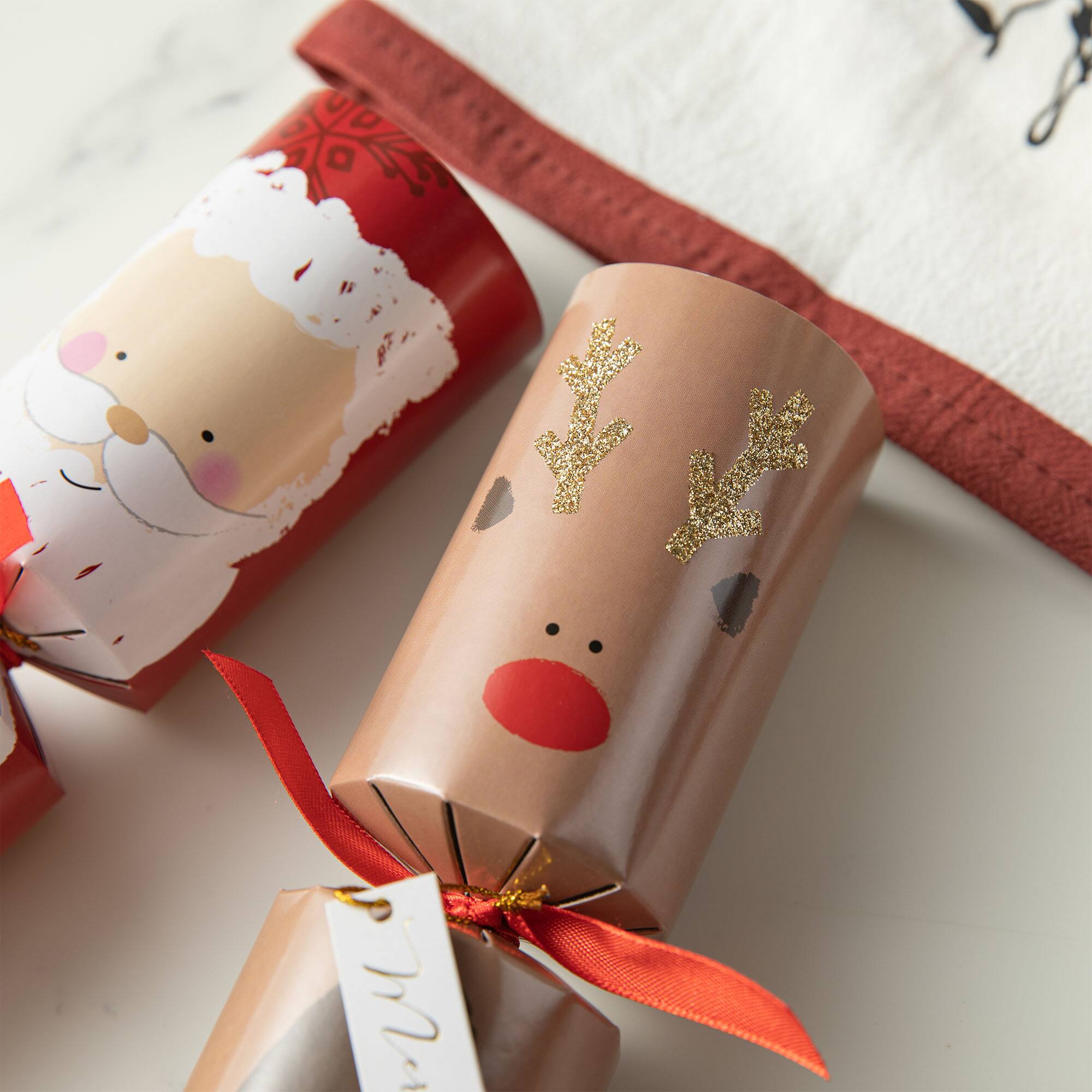 Glitzhome&#xAE; 12&#x22; Christmas Santa, Snowman, Penguin &#x26; Reindeer Party Cracker with Gift Contents, 6ct.