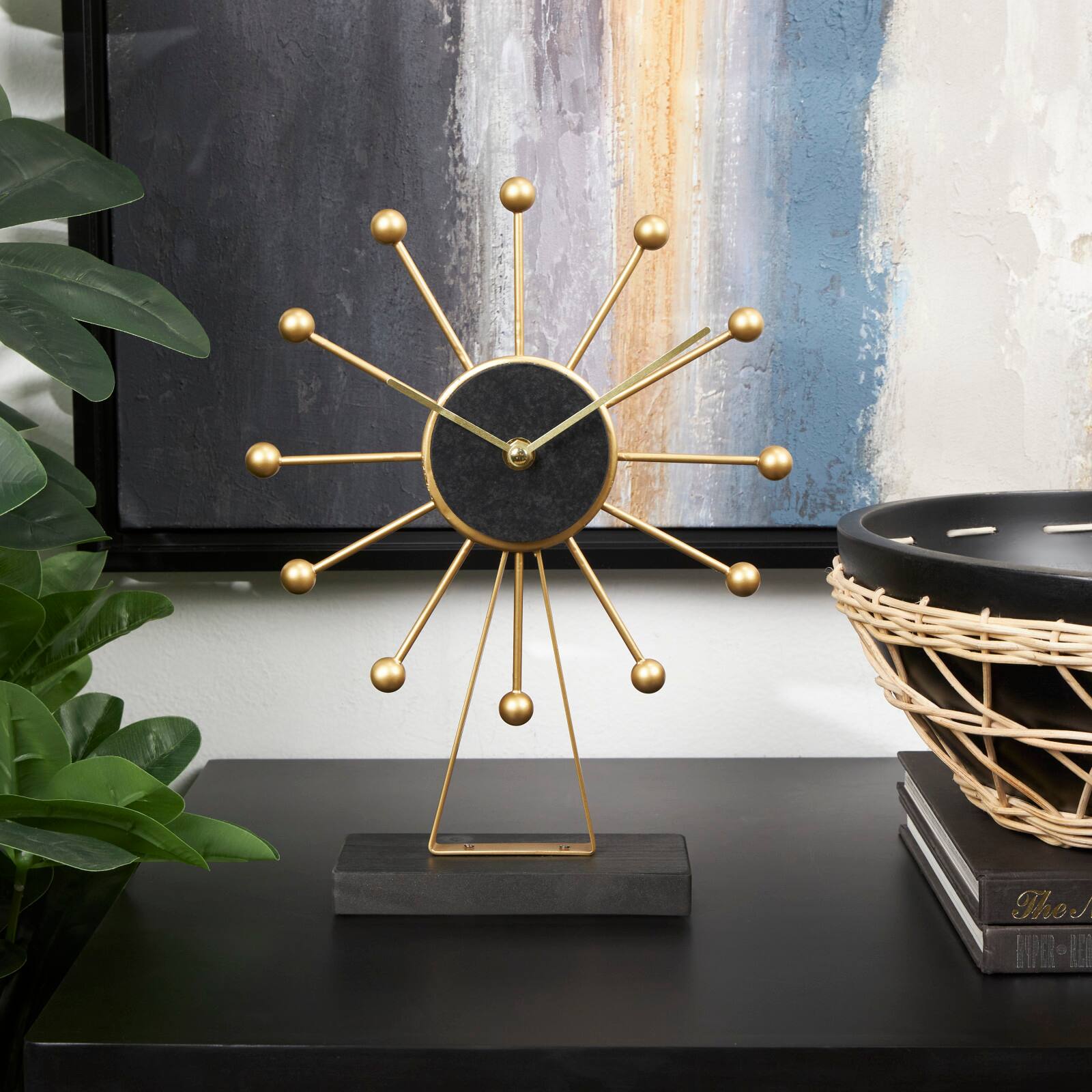 CosmoLiving by Cosmopolitan 12" Gold Metal Sunburst Clock with Black Base & Clockface