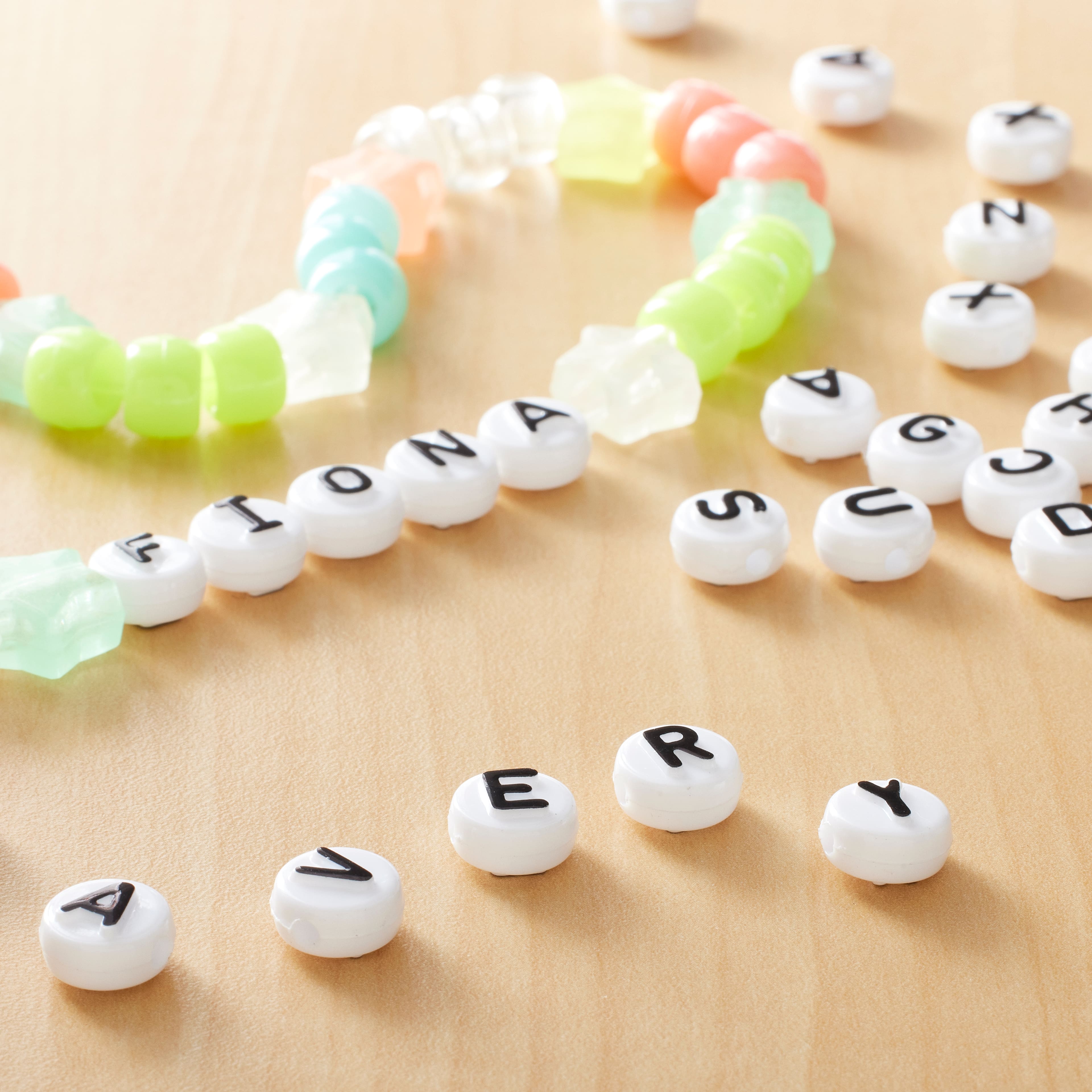 12 Packs: 100 ct. (1,200 total) White Circle Alphabet Beads by Creatology™, 10mm