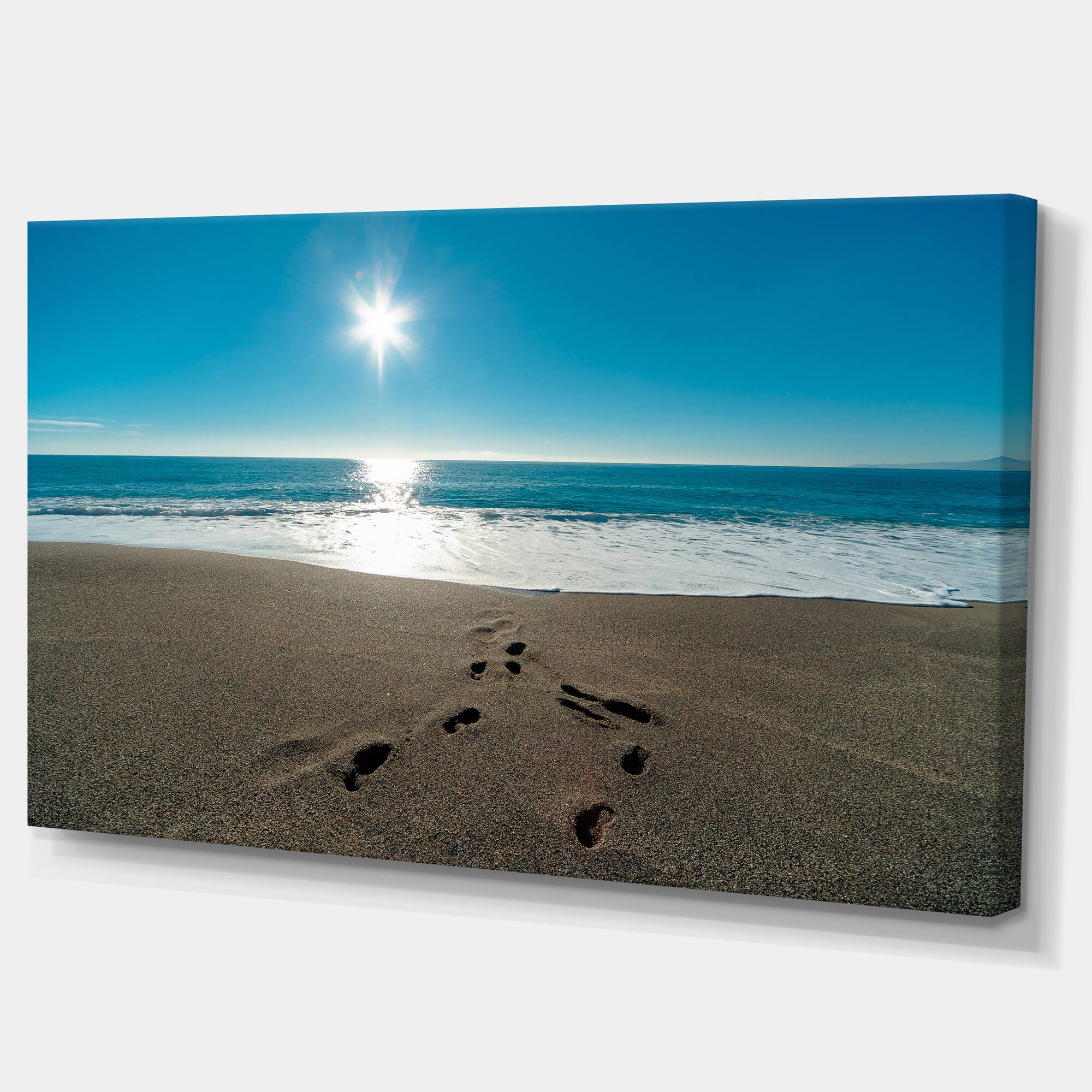 Designart - Blue Sea and Footprints in Sand - Large Seascape Art Canvas Print