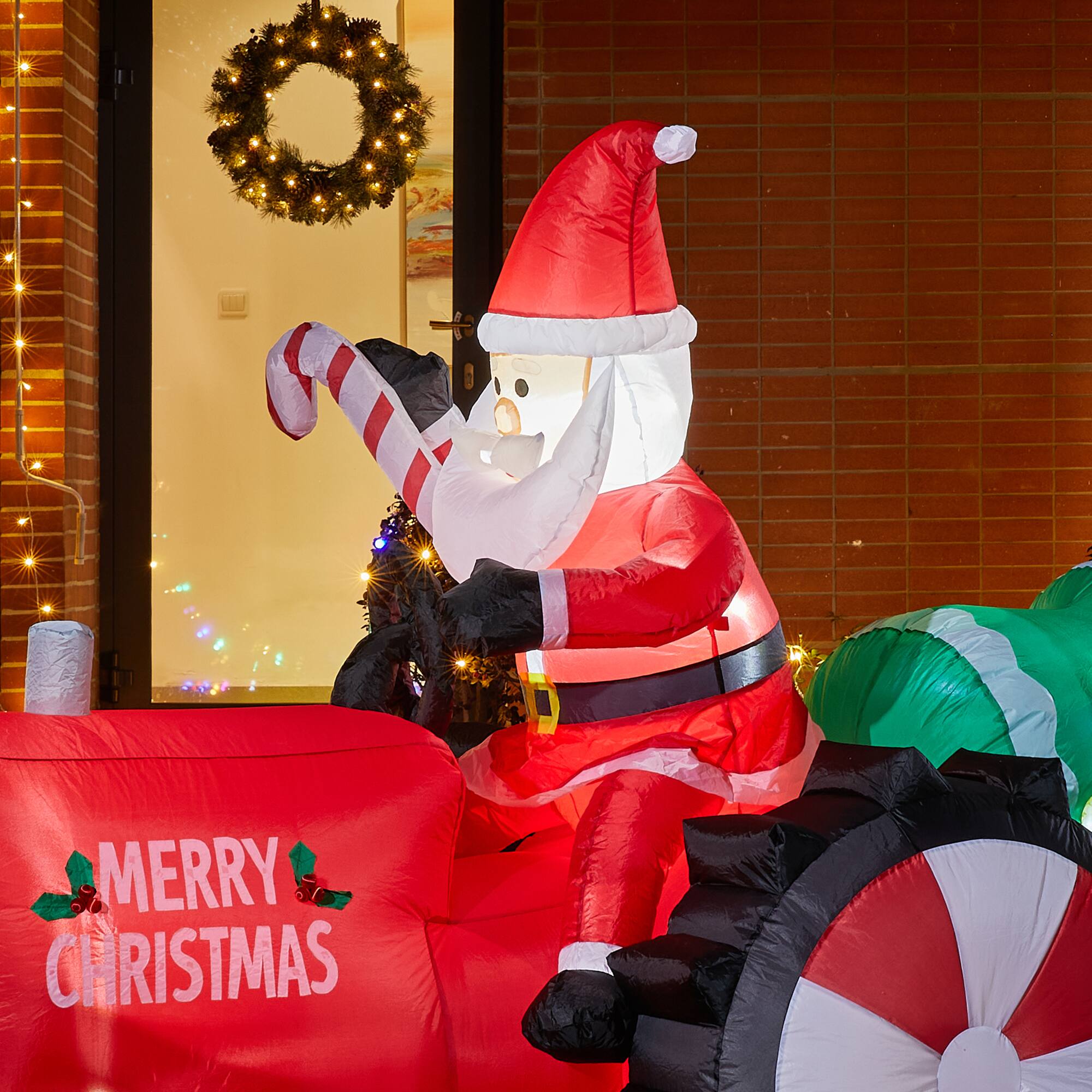 Glitzhome® 11ft. Lighted Inflatable Santa on Tractor Décor