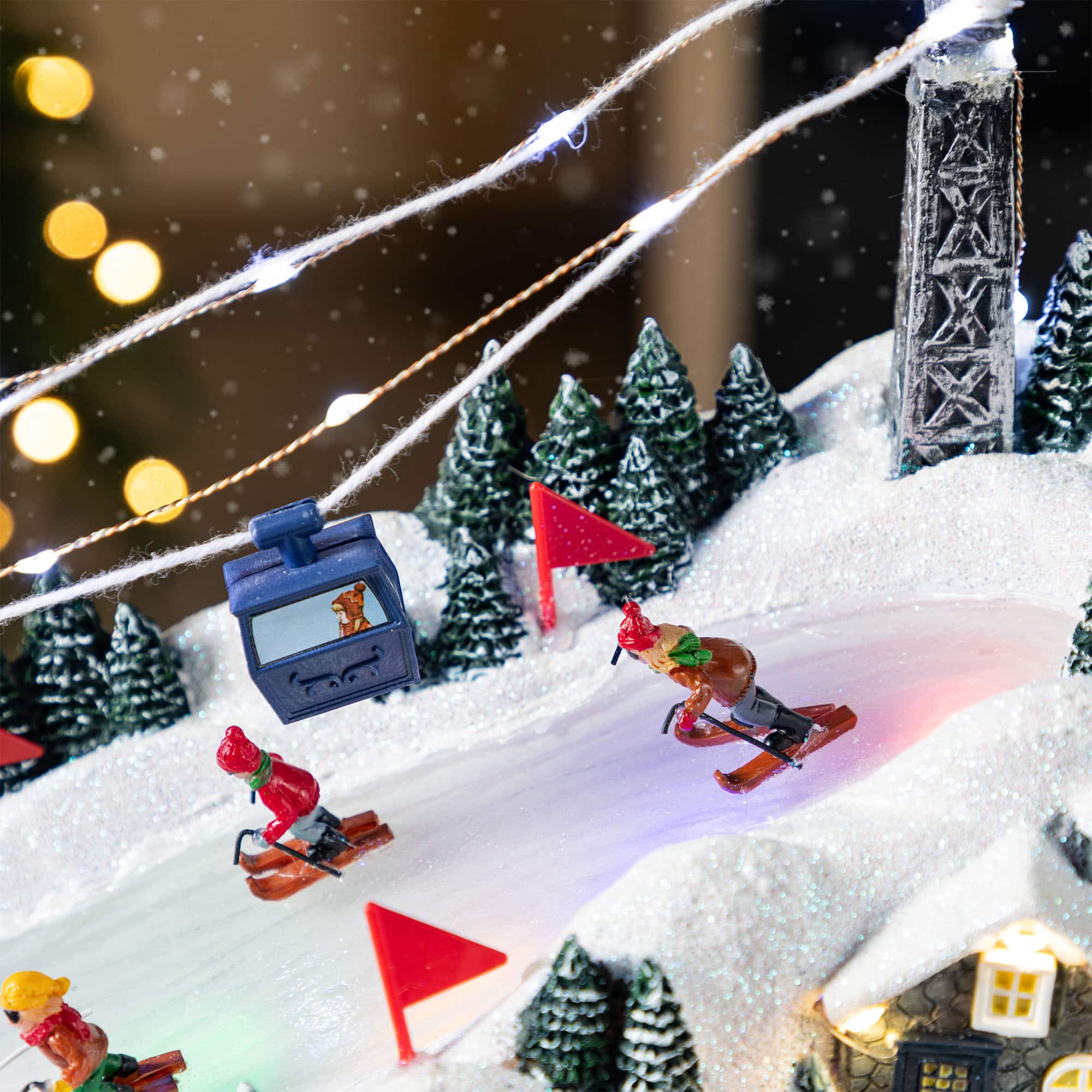 Glitzhome&#xAE; 16&#x22; Christmas Oversized Resin Lighted Musical Skiing Table Village Decor