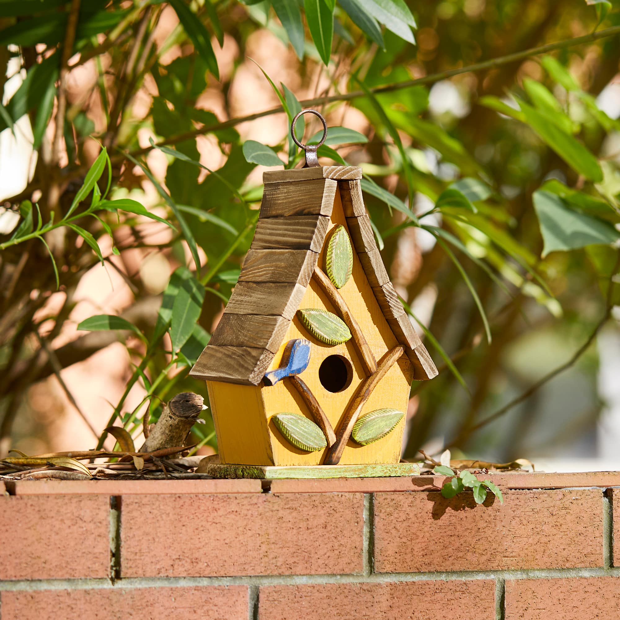 Glitzhome® 9.5" Yellow Distressed Wood Birdhouse with Leaves