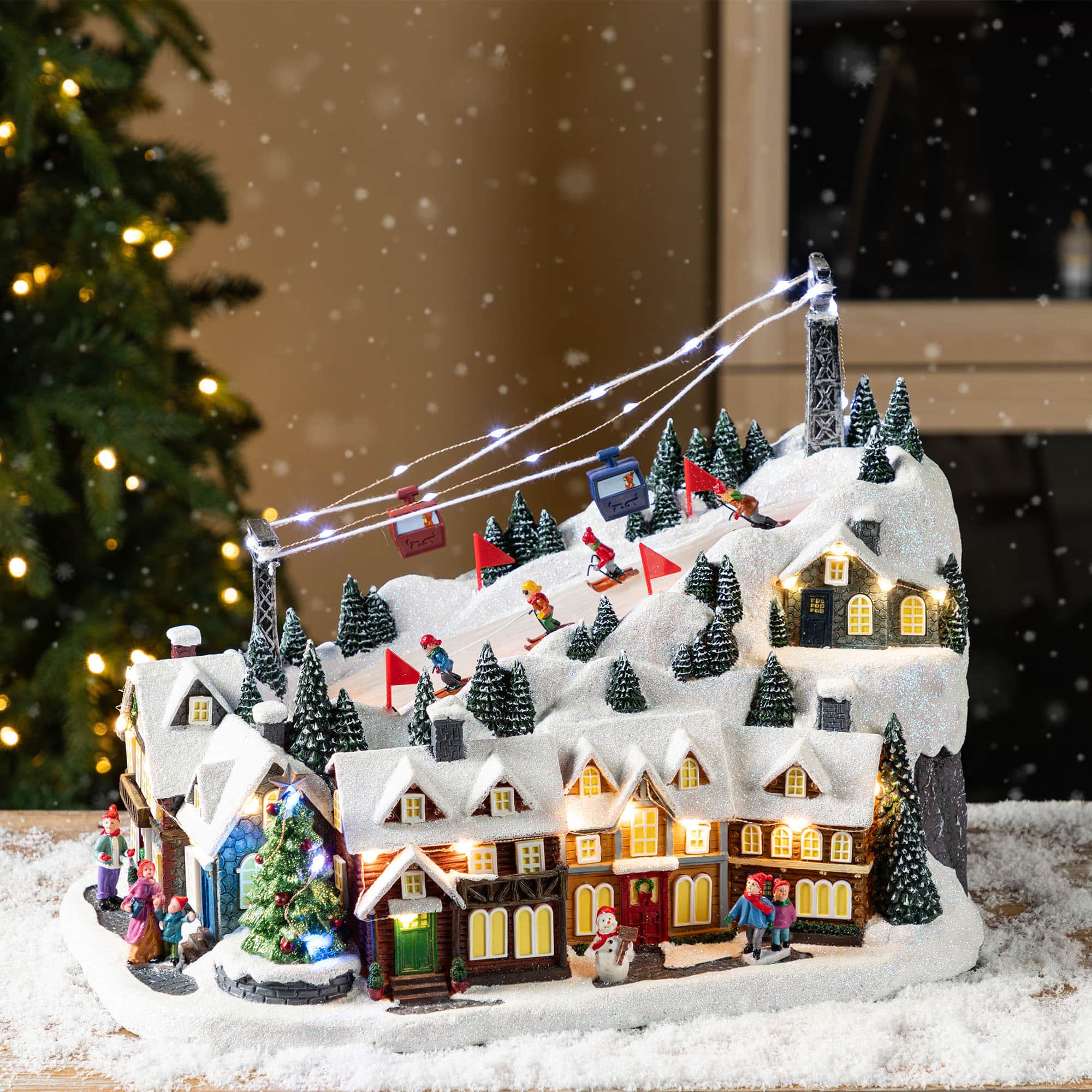 Glitzhome&#xAE; 16&#x22; Christmas Oversized Resin Lighted Musical Skiing Table Village Decor
