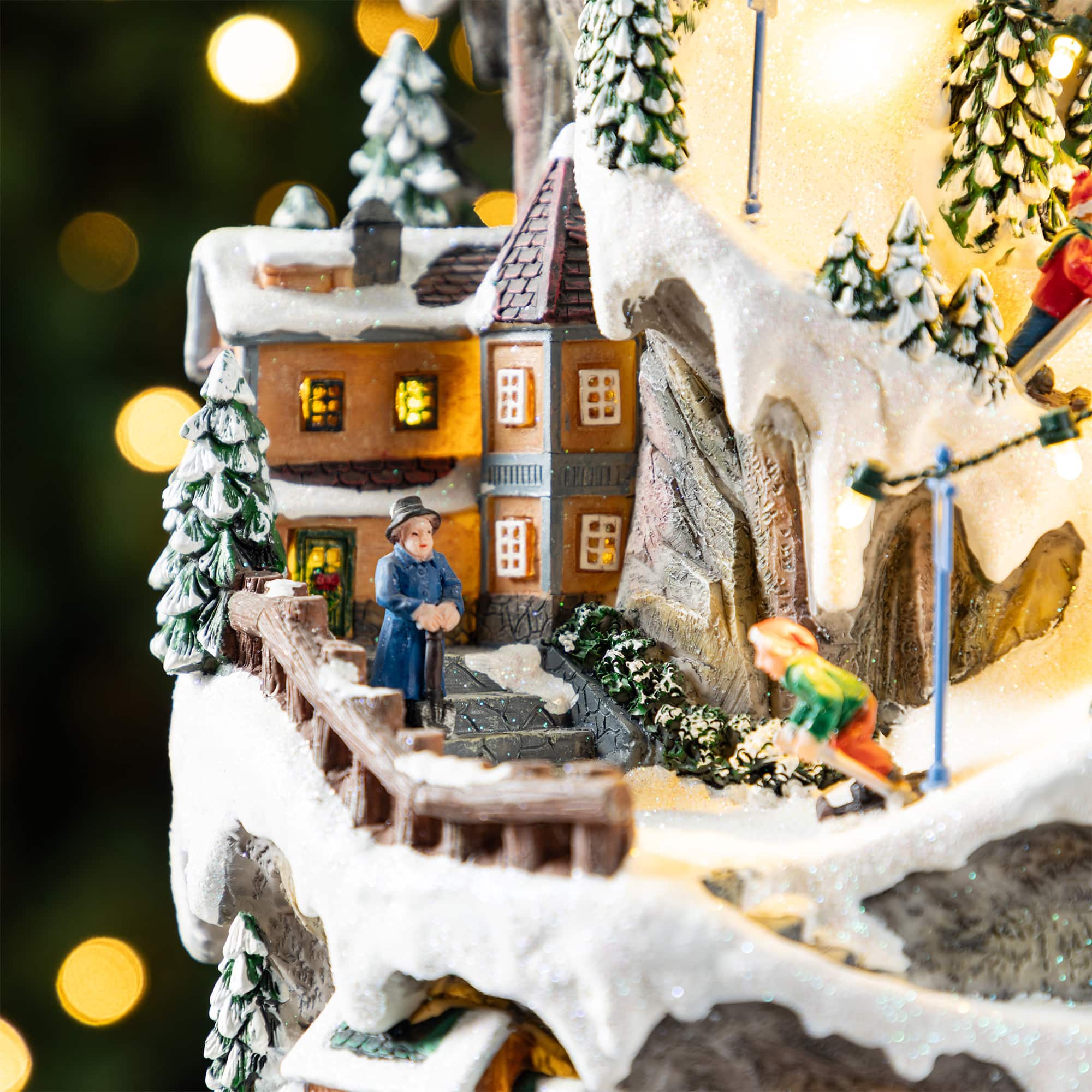 Glitzhome&#xAE; 15.5&#x22; Lighted Christmas Skiing Moutain Resin Village with Movement and Music
