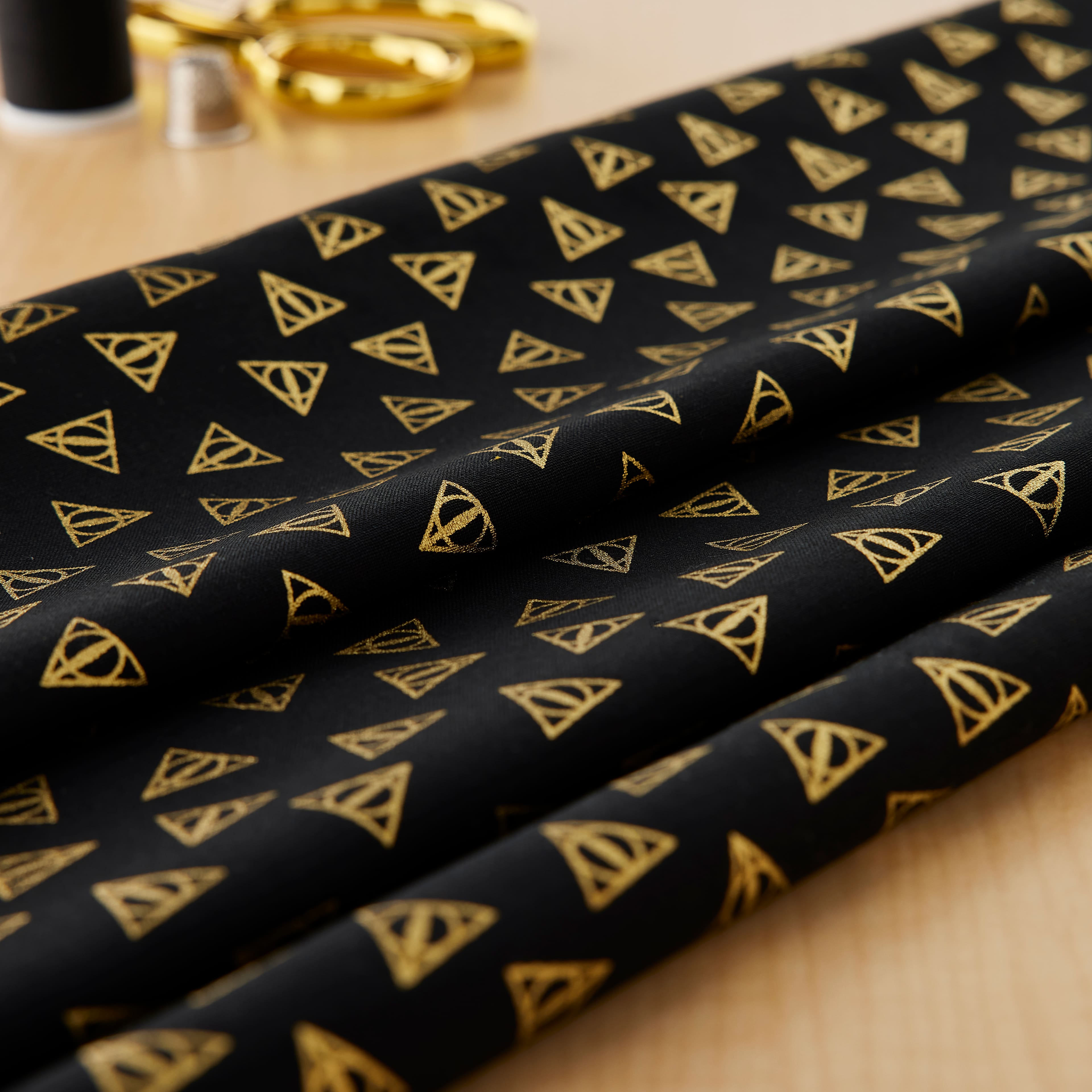 Camelot&#xAE; Fabrics Harry Potter&#x2122; Metallic Gold Deathly Hallows&#x2122; Cotton Fabric