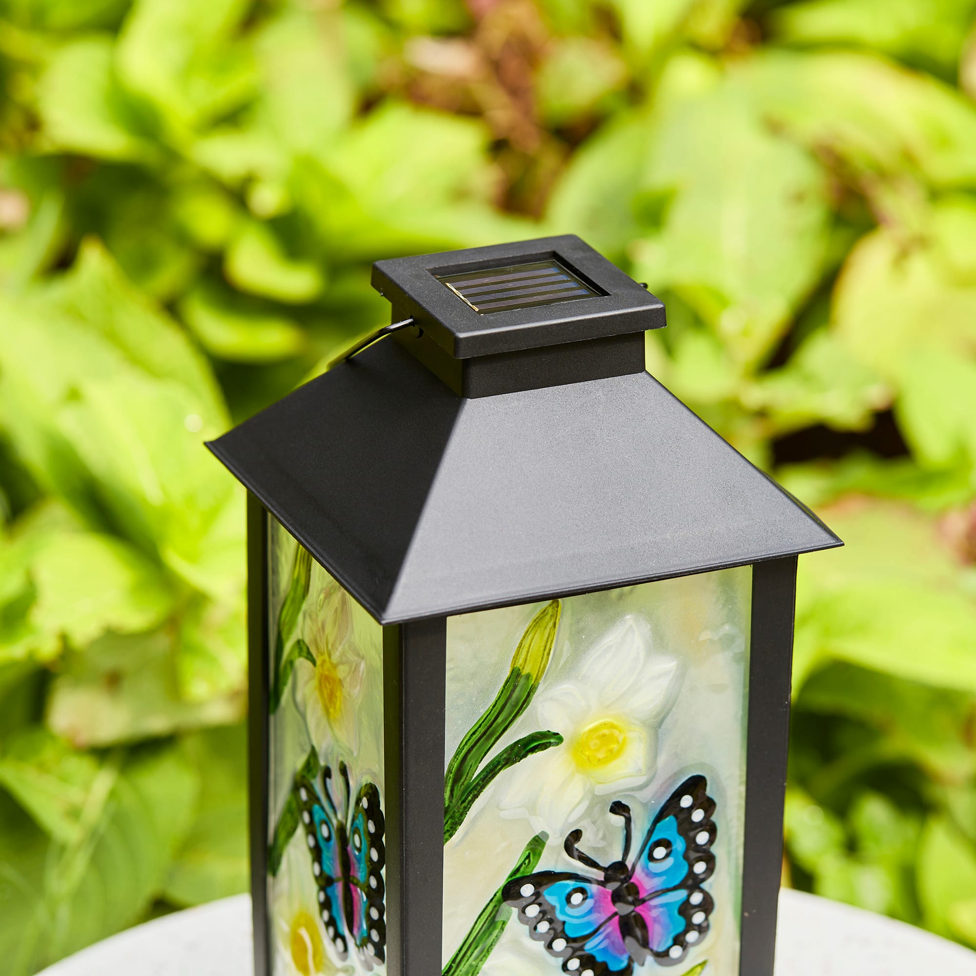 Glitzhome&#xAE; 11&#x22; Glass with Butterfly &#x26; Flower Pattern Solar Powered Hanging Lanterns, 2ct.
