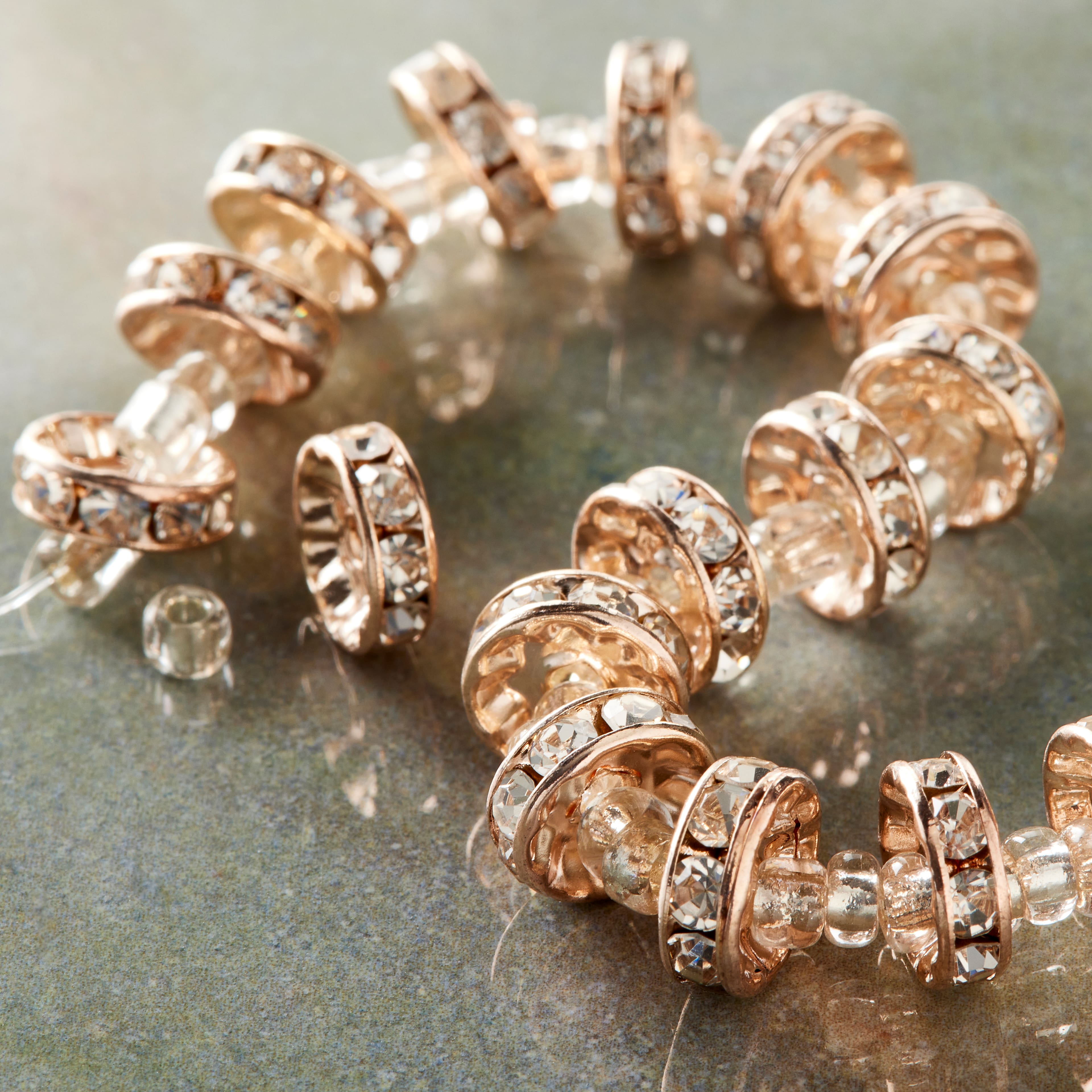 12 Pack: Rose Gold Rhinestone Studded Rondel Beads, 10mm by Bead Landing&#x2122;