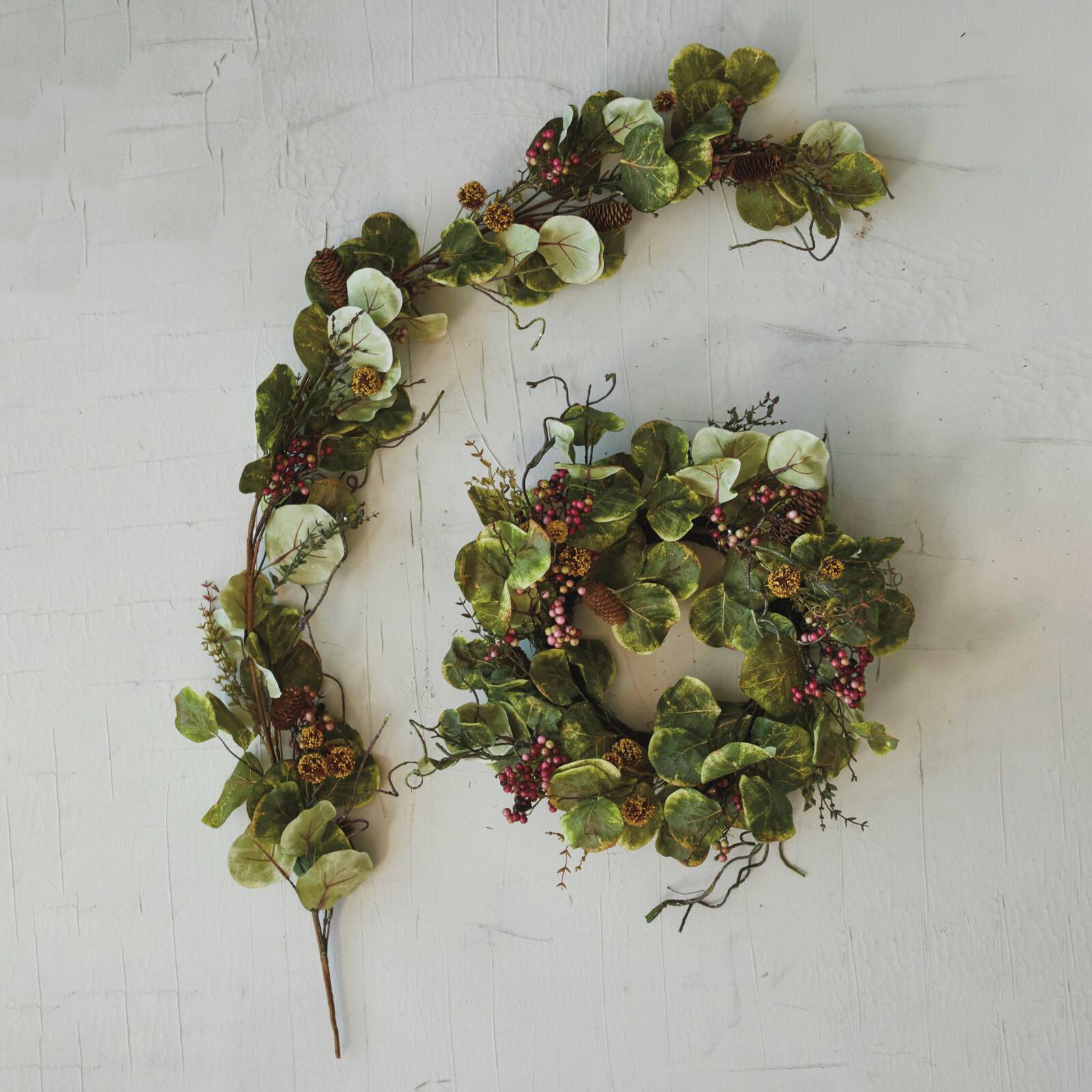Hello Honey® 5.5ft. Faux Zanzibar Leaf Garland with Pinecones & Berries