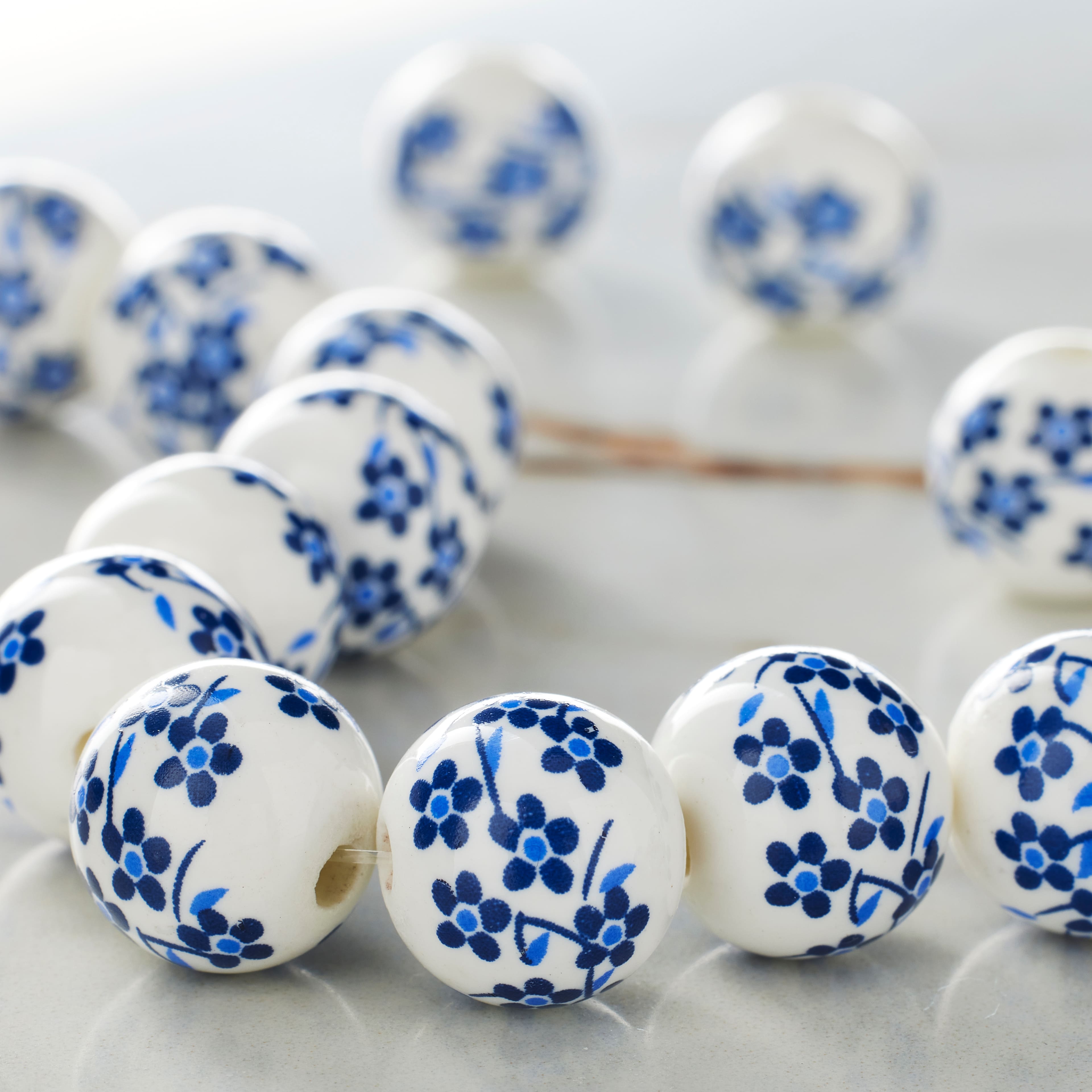 12 Pack: White &#x26; Sapphire Ceramic Round Beads, 12mm by Bead Landing&#x2122;