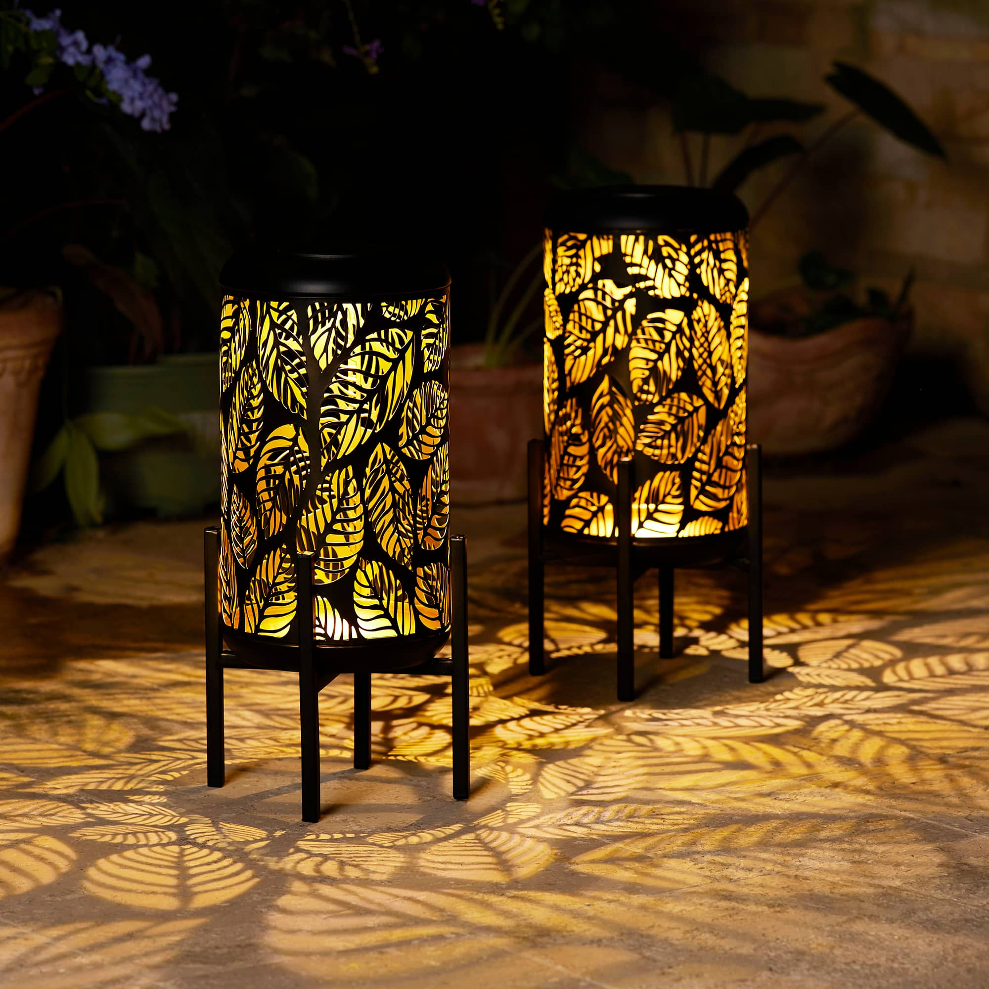 Glitzhome&#xAE; 14.25&#x22; Black Metal Cutout Leaves Pattern Solar Powered LED Outdoor Lantern, 2ct.