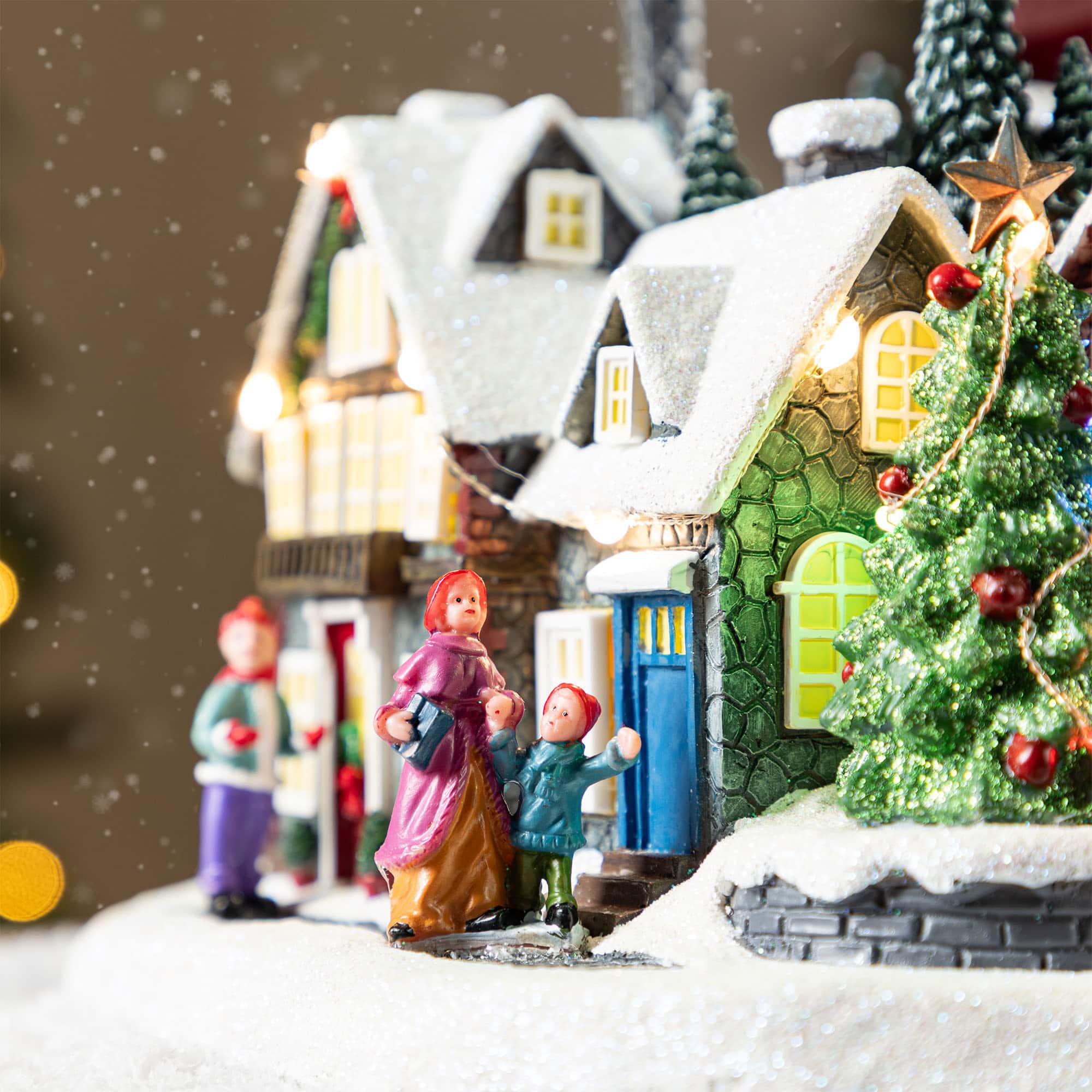 Glitzhome&#xAE; 16&#x22; Christmas Oversized Resin Lighted Musical Skiing Table Village Decor